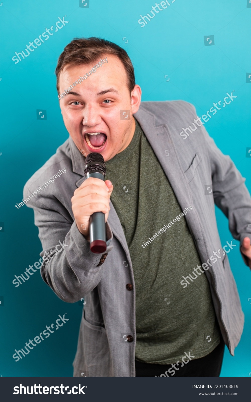 Man Singing Holding Microphone Stock Photo 2201468819 Shutterstock