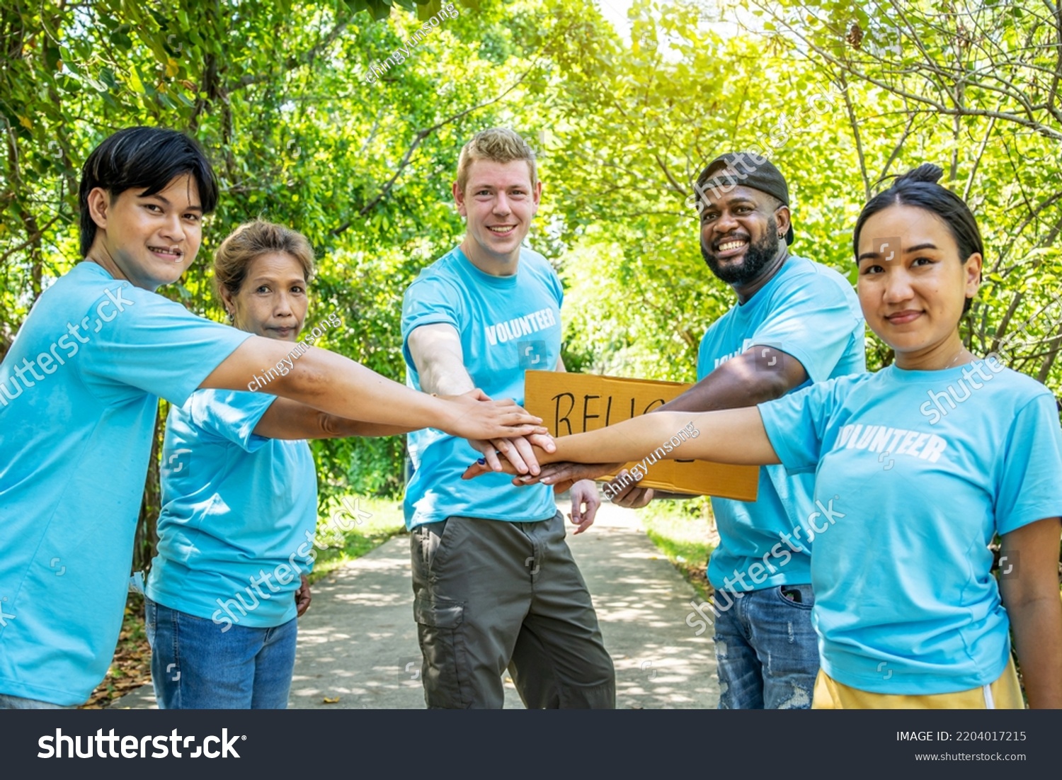 Group volunteers stand put your hands stock photo 2204017215 shutterstock