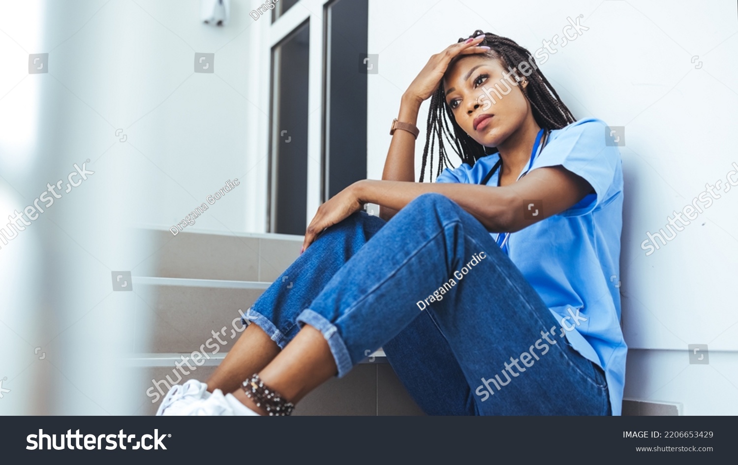 Female Nurse Sitting On Floor Looking Stock Photo 2206653429 | Shutterstock