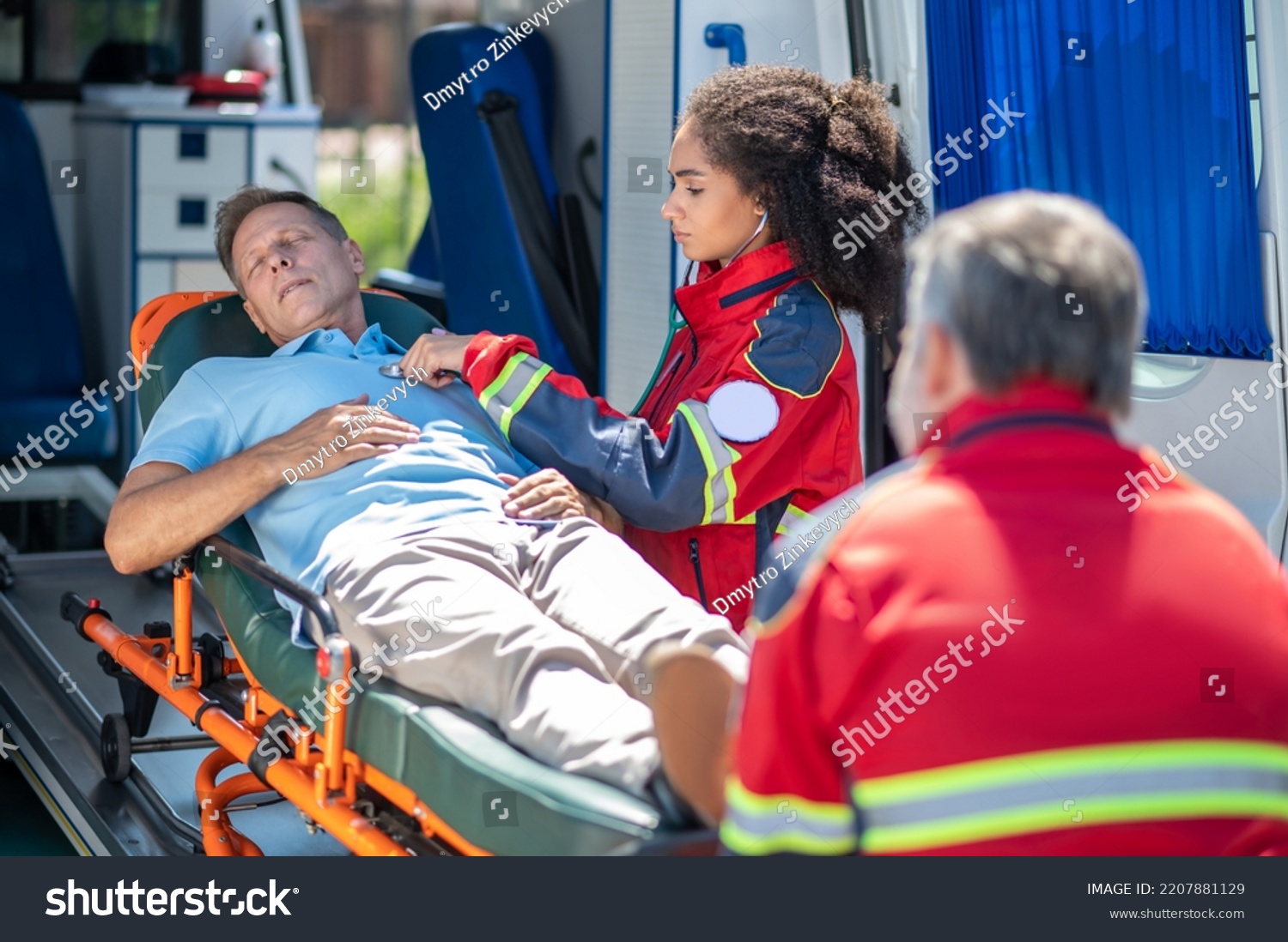 Paramedic Examining Unconscious Man Lying Down Stock Photo 2207881129 ...