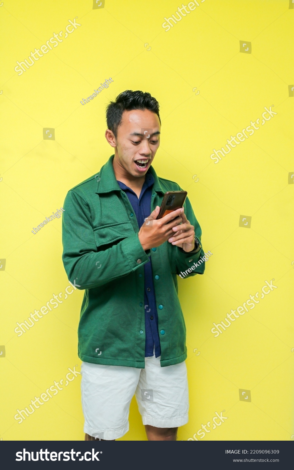 man-wearing-blue-shirt-green-jacket-stock-photo-2209096309-shutterstock