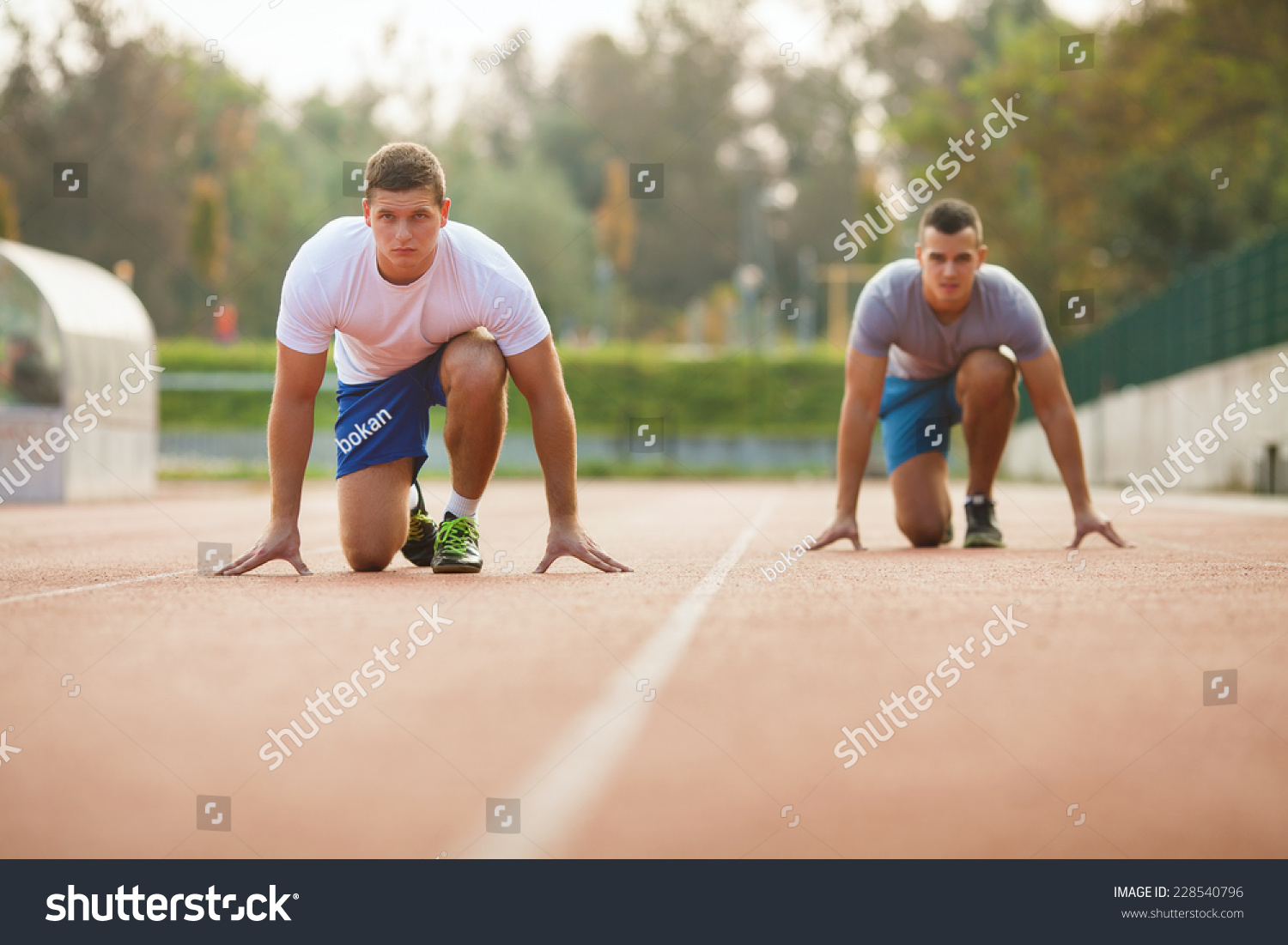 Two Young Athletes At Starting Position Ready To Start A Race