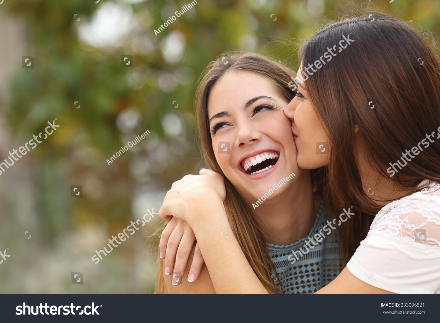 two-funny-affectionate-women-friends-laughing-stock-photo-233096821