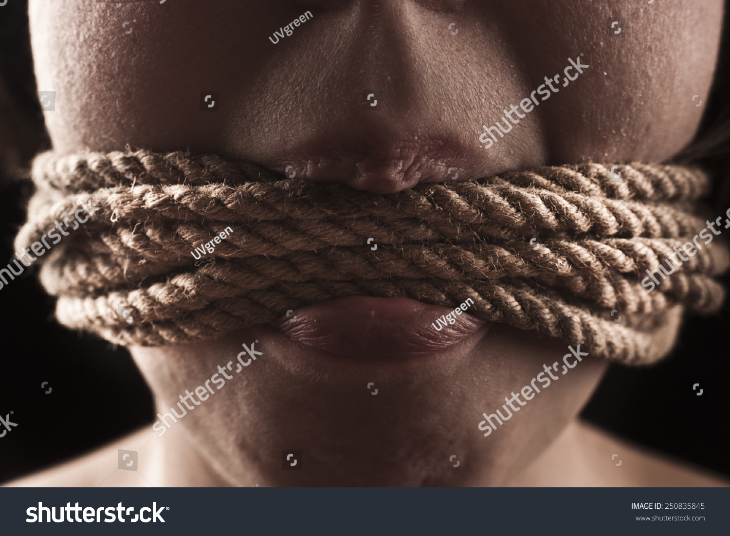 Стоковая фотография 250835845: Submissive Girl Gagged Rope On Black Shutter...