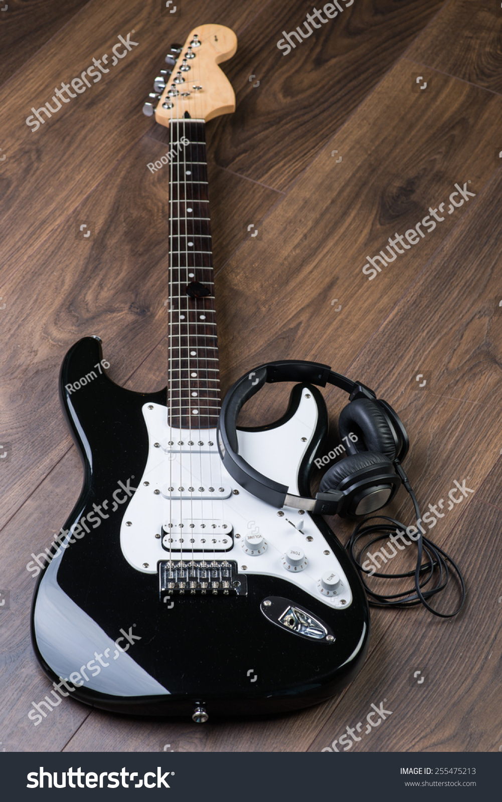 playing electric guitar with headphones