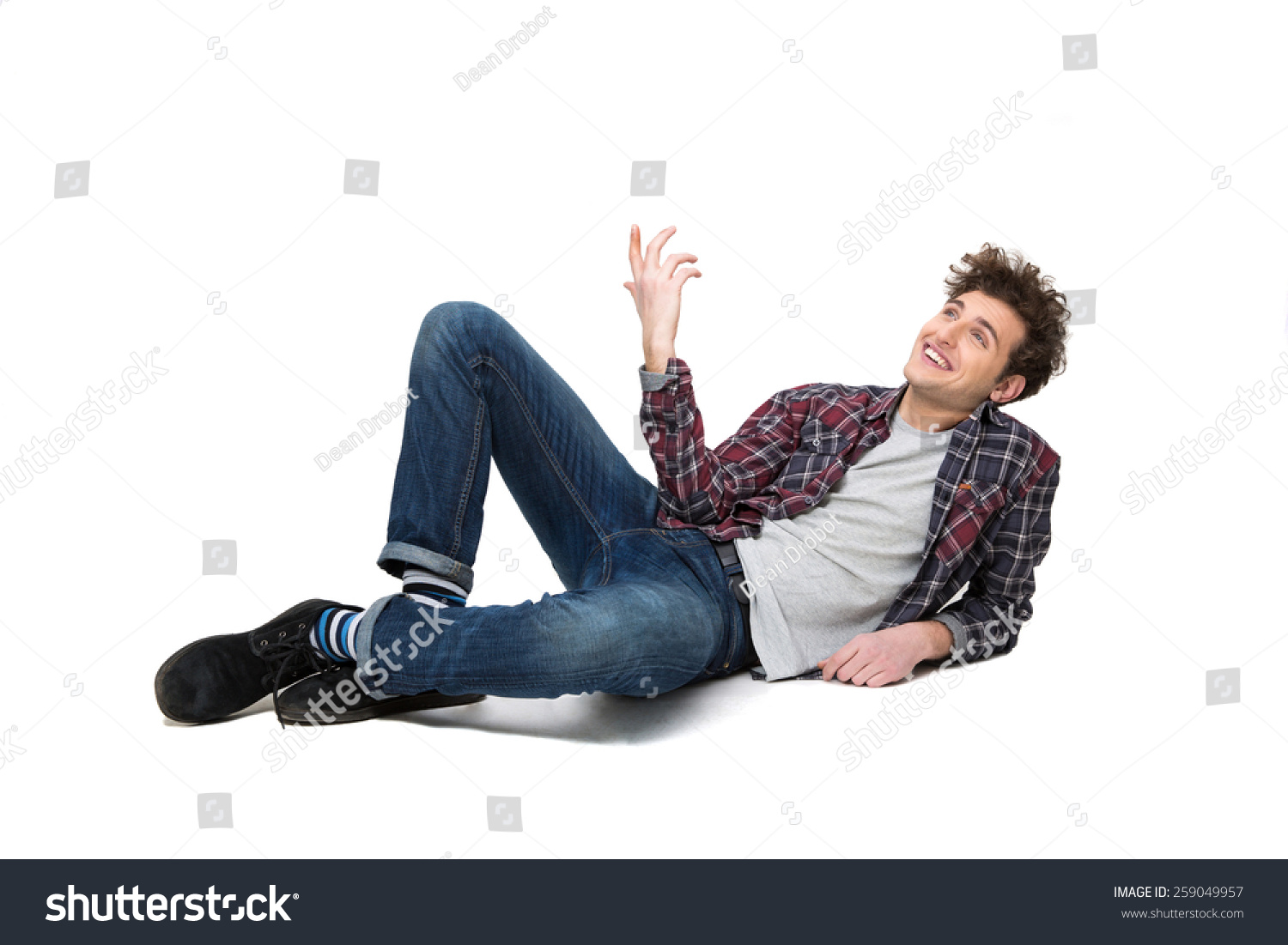 happy-thoughtful-young-man-lying-on-stock-photo-259049957-shutterstock