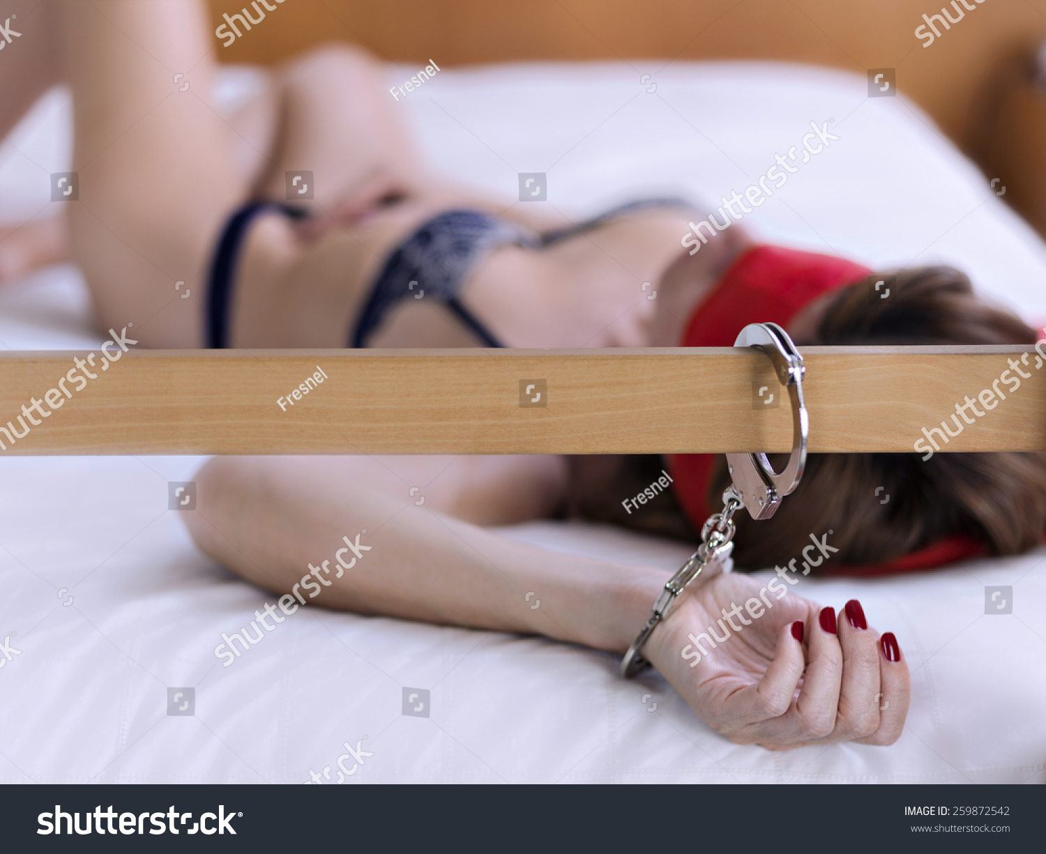 Woman Handcuffed Wooden Headboard Bed