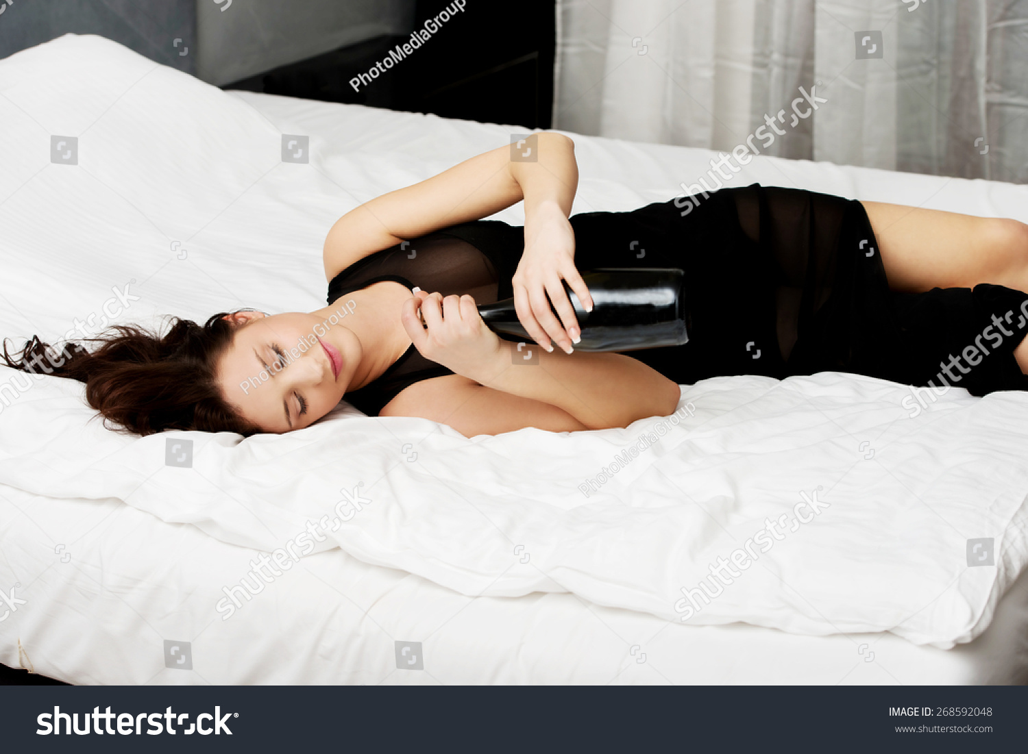 Drunk Woman Sleeping On Bed Bottle