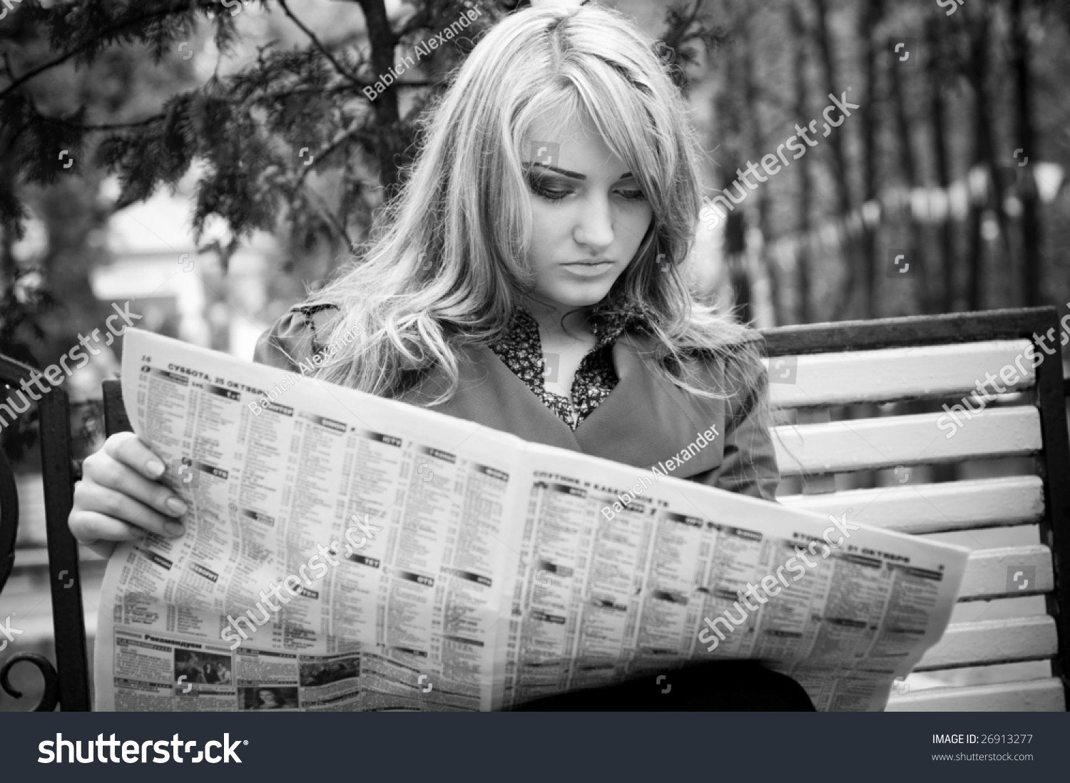 woman reading newspaper black and white