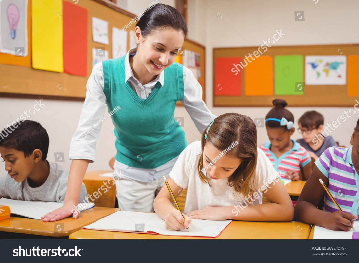 Teacher Helping Little Girl During Class Stock Photo 309240797 ...