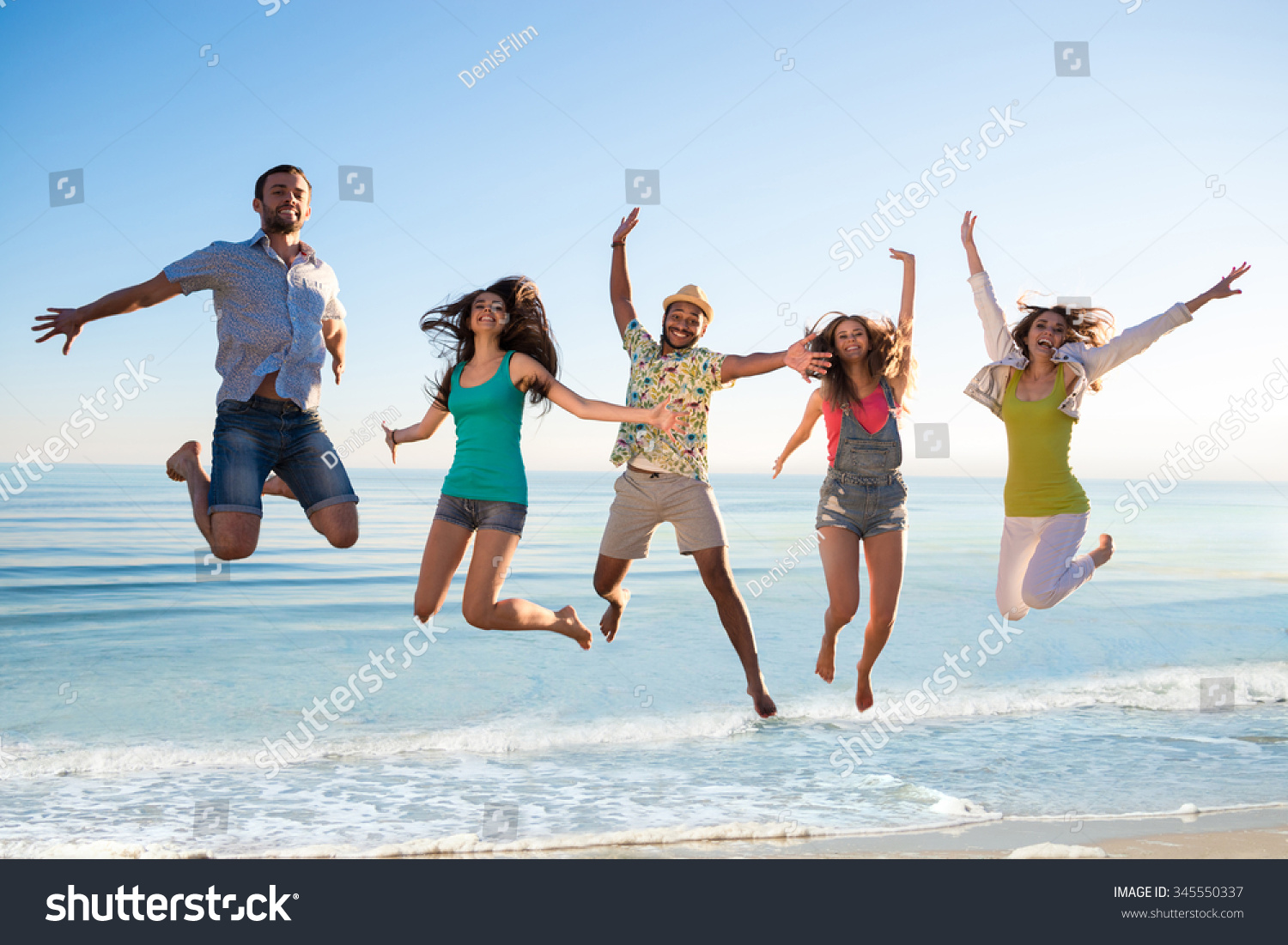 Cheerful Young People Jumping On Beach Stock Photo 345550337 | Shutterstock