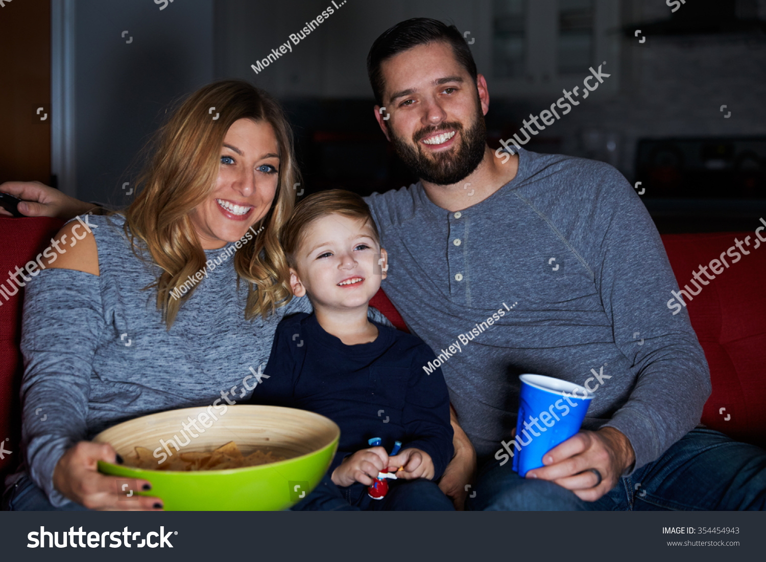 Family Sitting On Sofa Watching Television Stock Photo 354454943   Stock Photo Family Sitting On Sofa Watching Television Together 354454943 