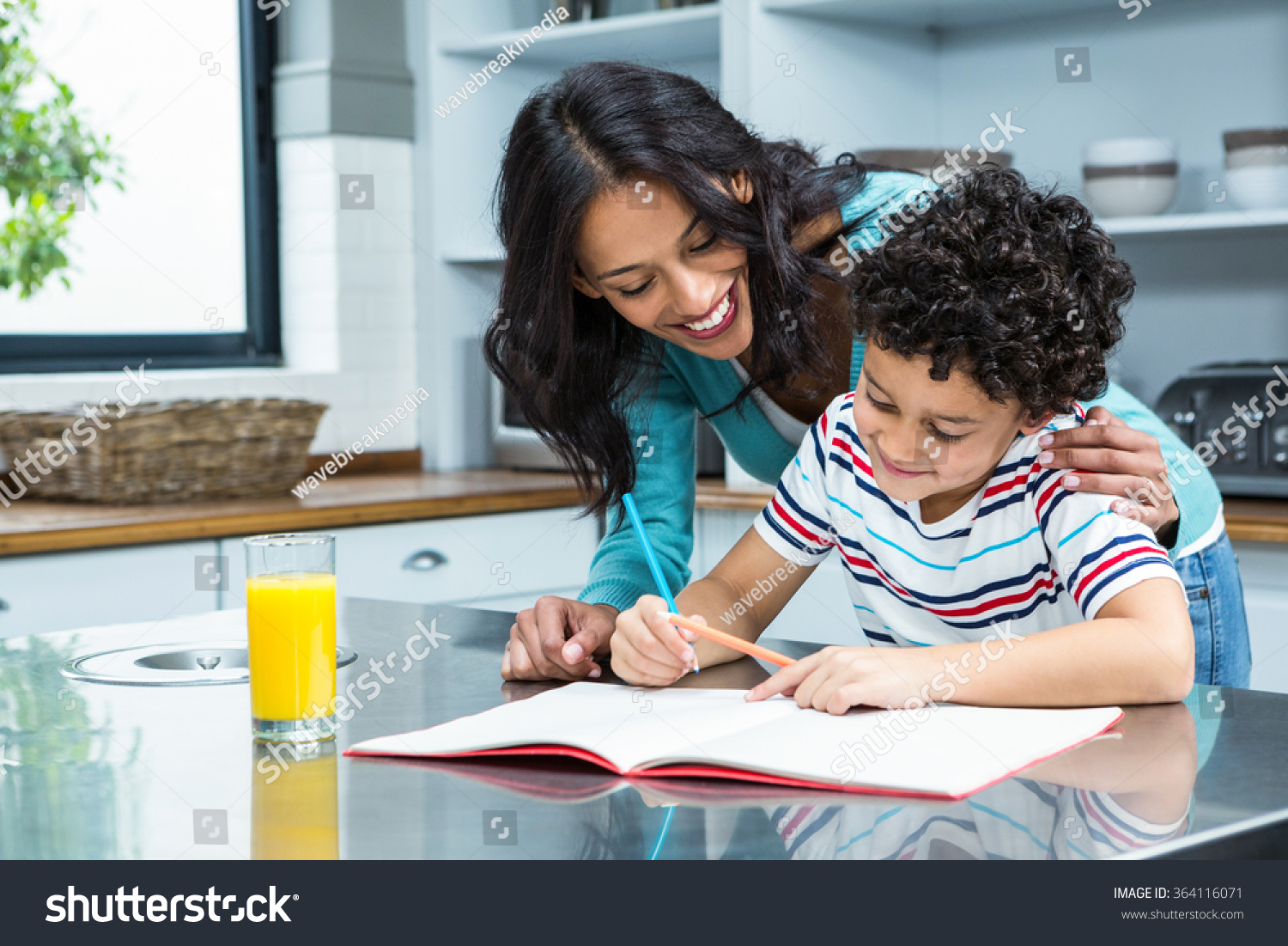 She help her mum. Mother and child doing homework. Parents and children at Home doing homework. Mother helping to the childrens homework. Study at the Home for the parents.