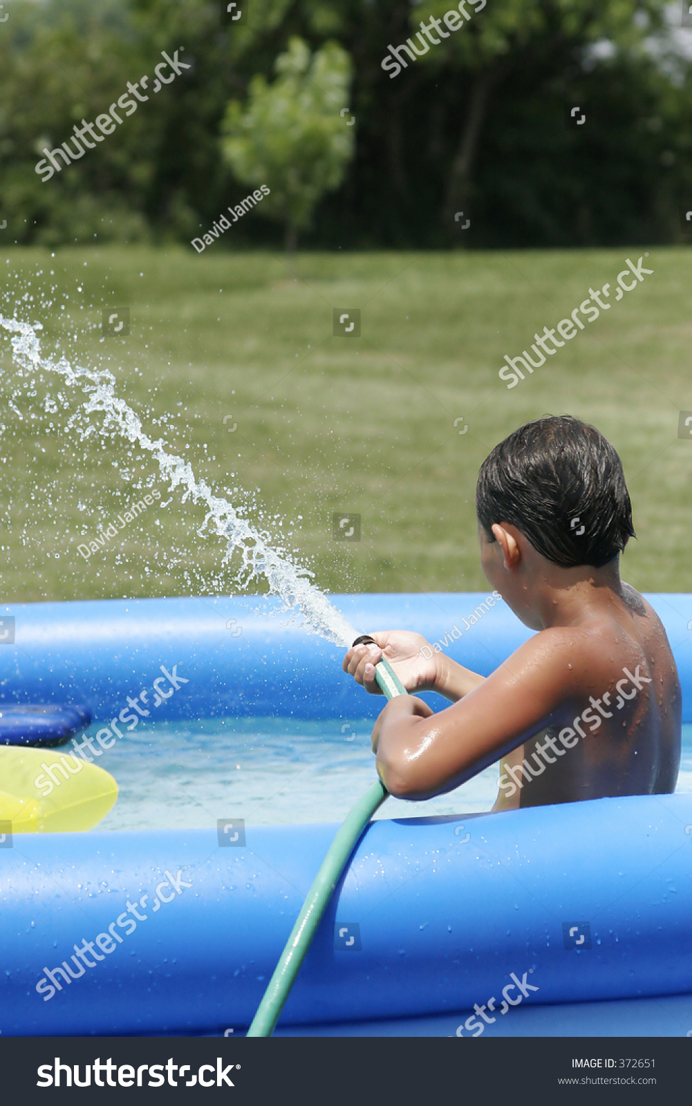 Boy Squirting Water Hose Pool Stock Photo 372651 | Shutterstock