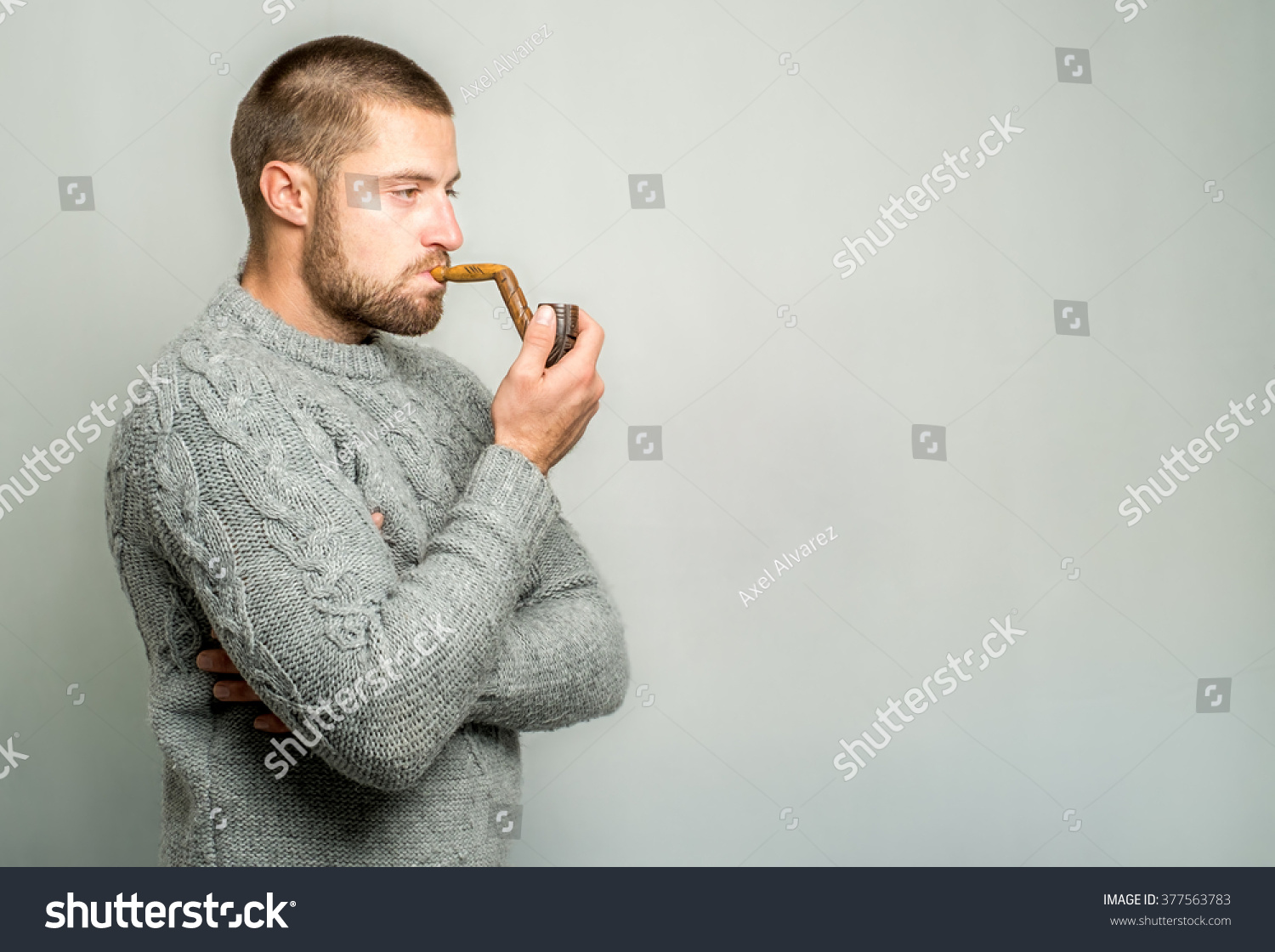 stock-photo-young-man-thinking-and-smoking-pipe-377563783.jpg