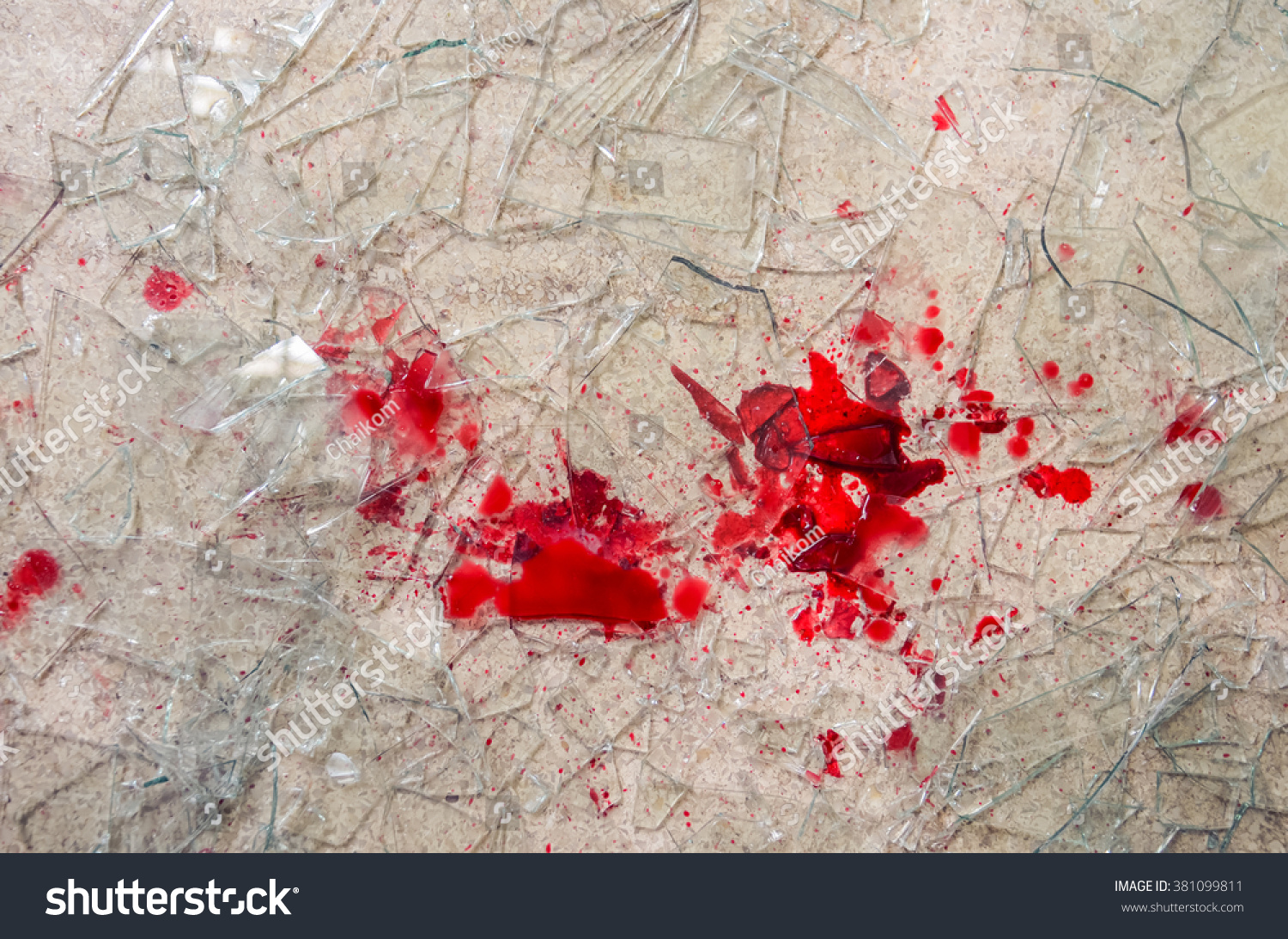 shattered glass on the floor with blood