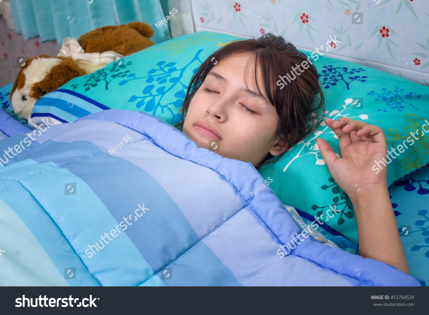 teen-girl-sleeping-on-her-bed-stock-photo-412794529-shutterstock