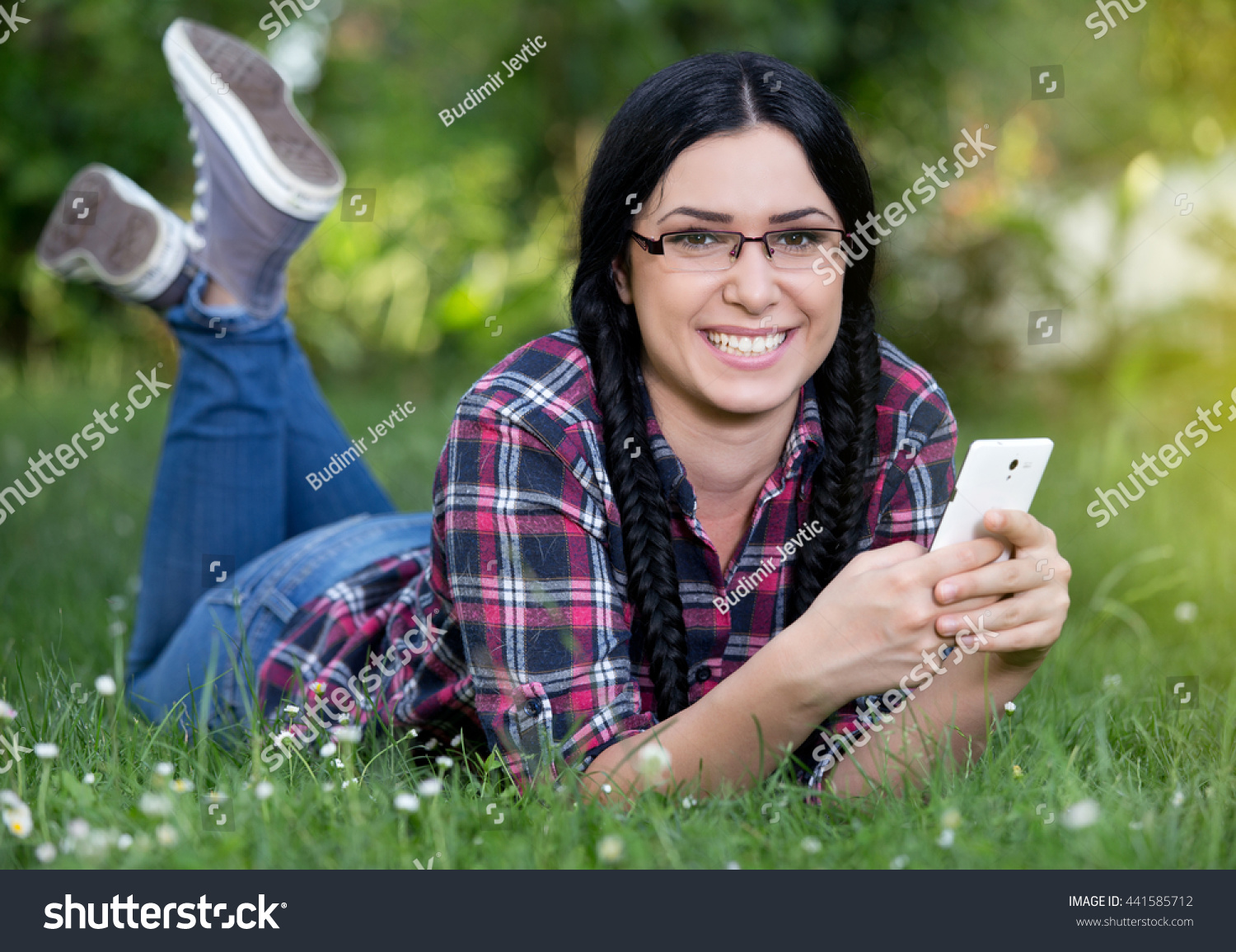 pretty-young-girl-lying-on-stomach-stock-photo-441585712-shutterstock