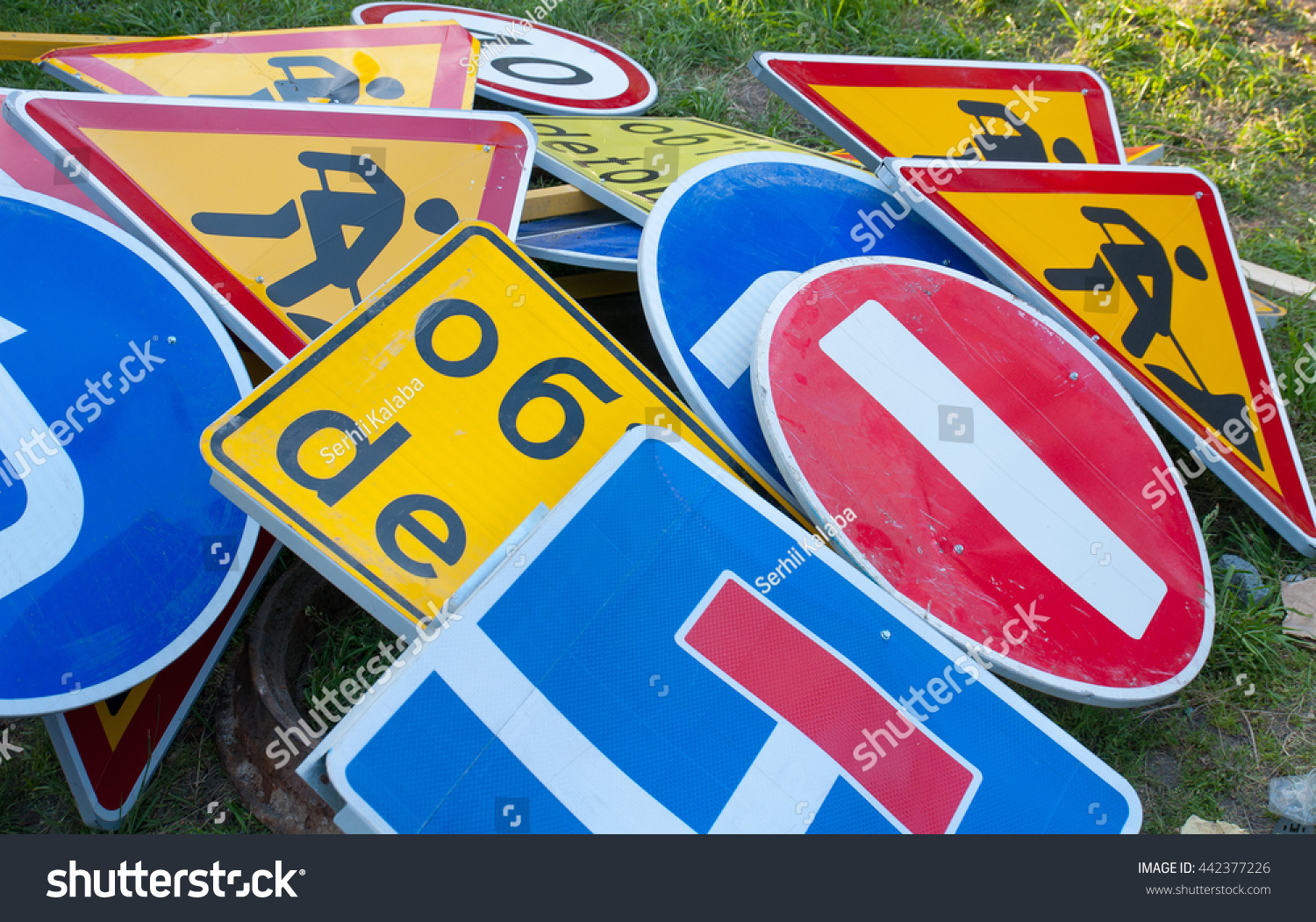 many-road-signs-stacked-on-floor-stock-photo-442377226-shutterstock