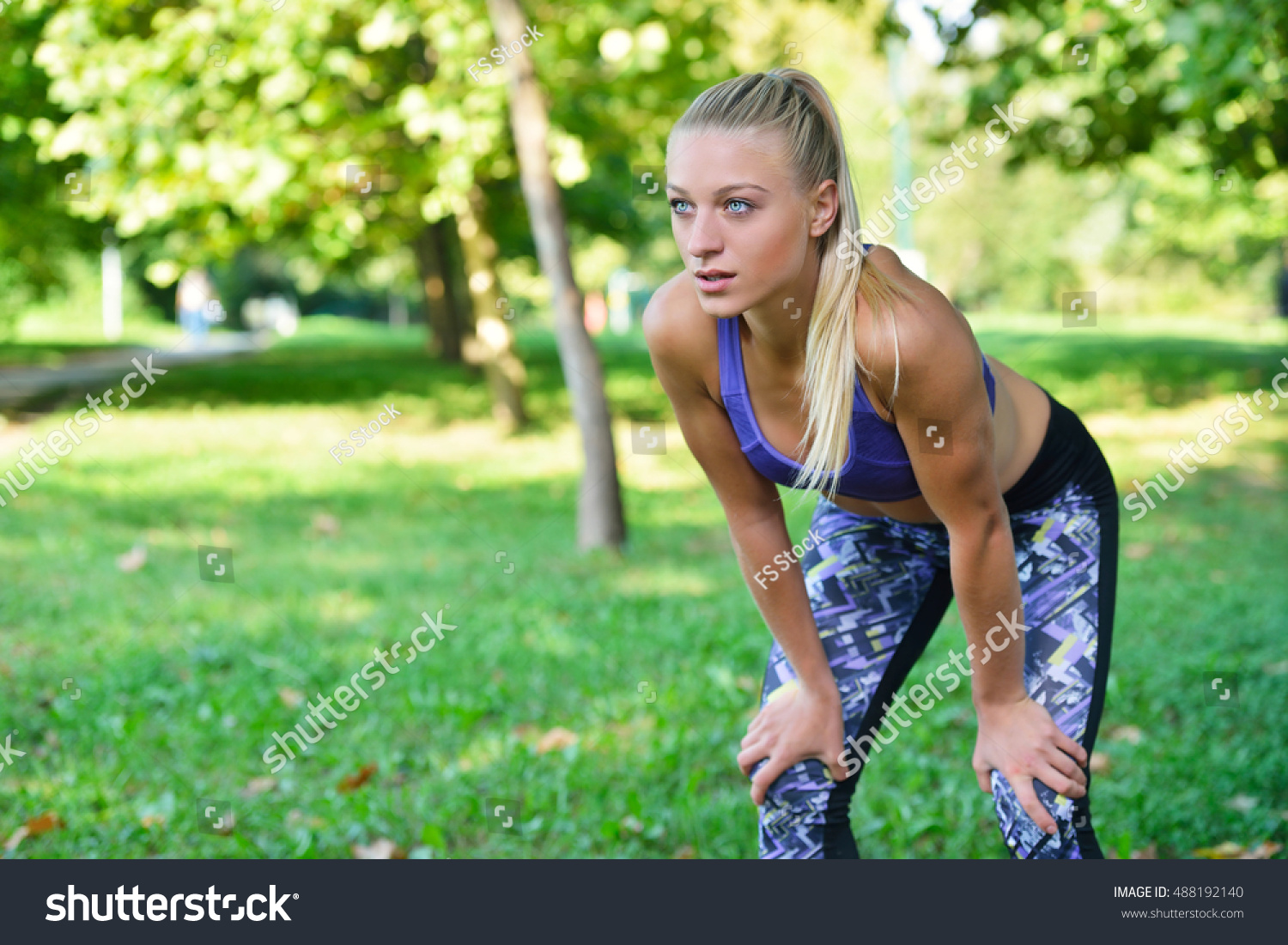 Young Woman Standing Bent Over Catching pic