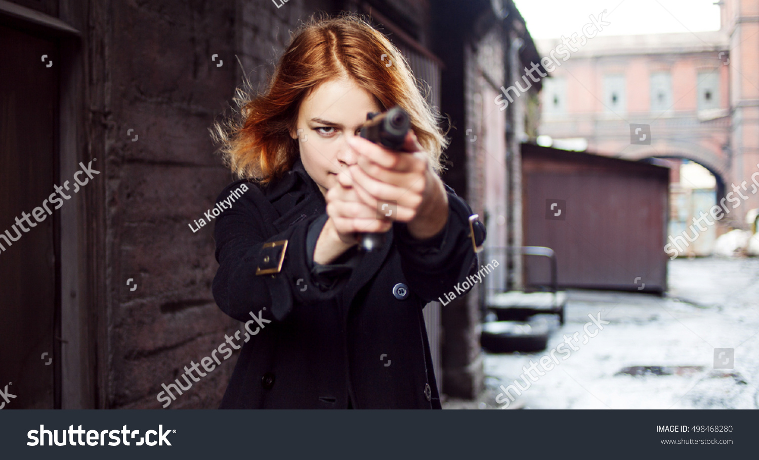 gun pointed at girl stock photo