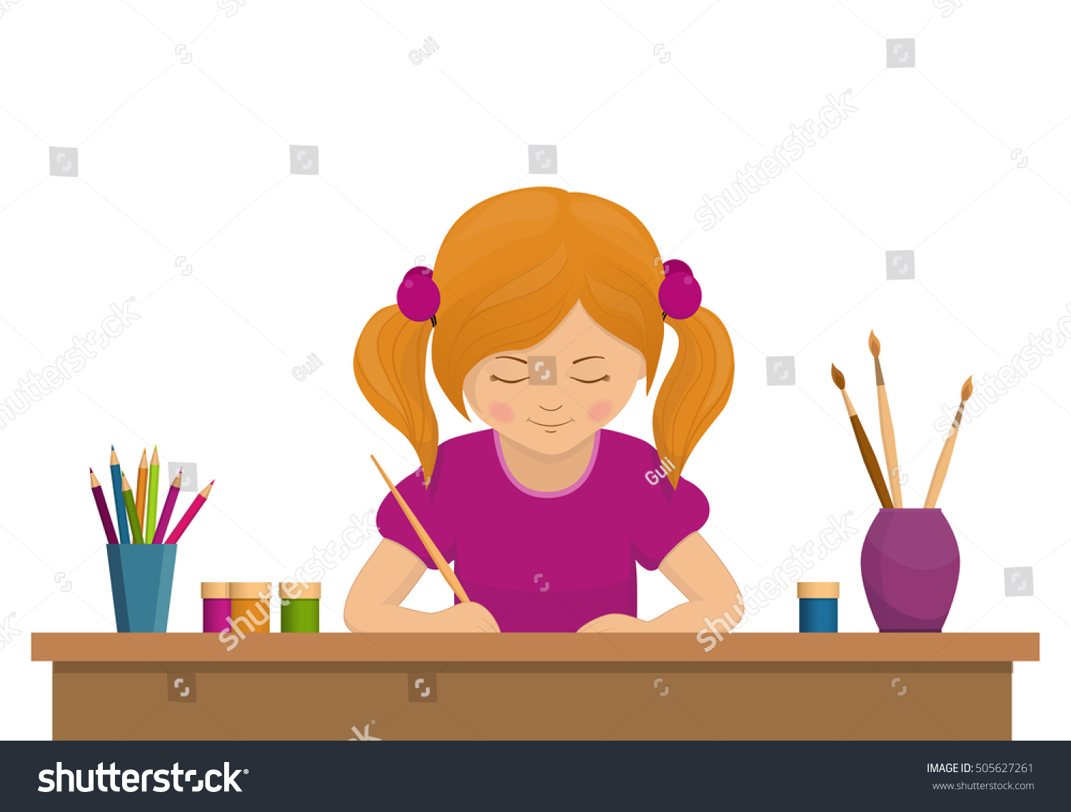 Девочка рисует за столом