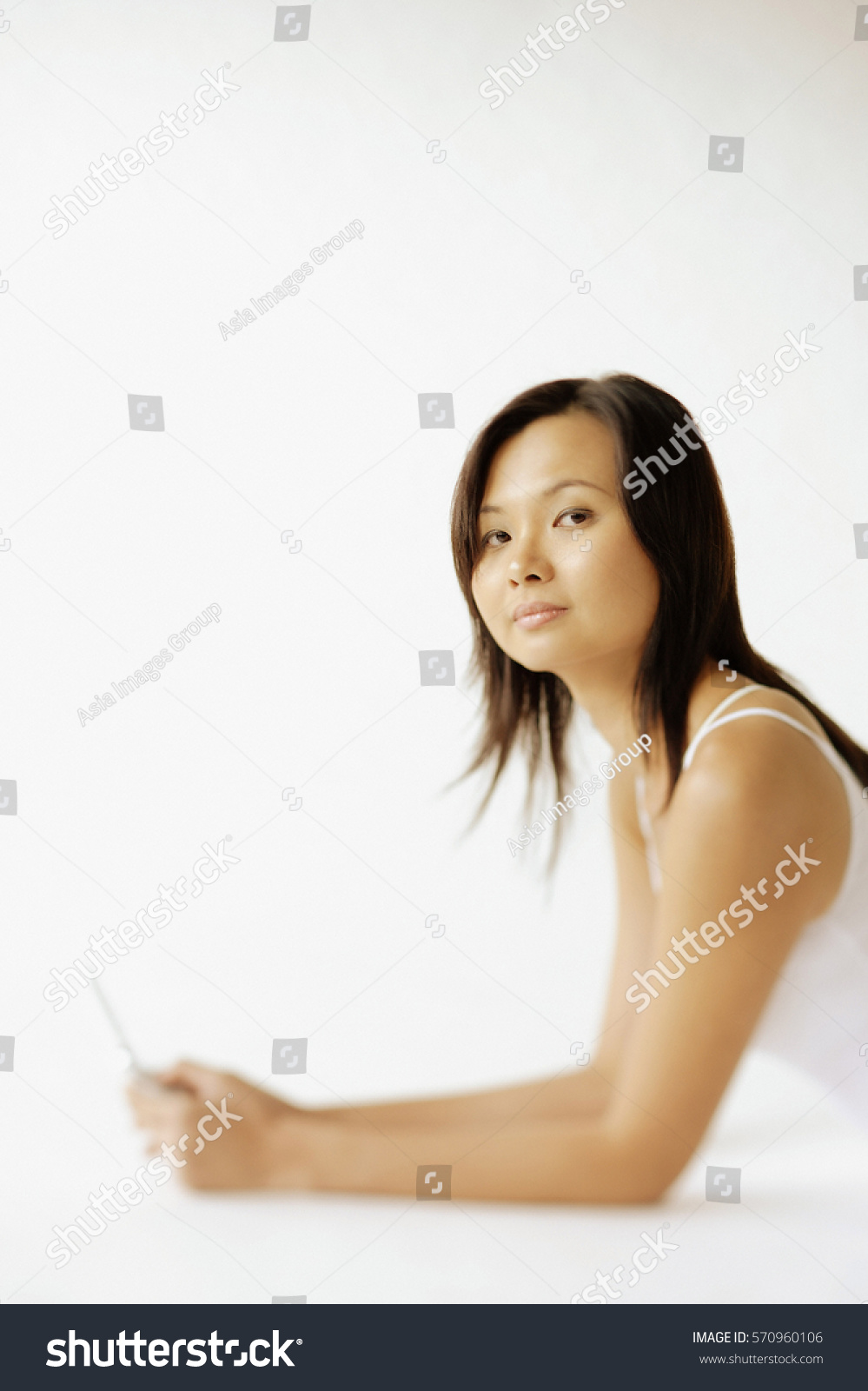 Young Woman Lying On Floor Holding Stock Photo 570960106 | Shutterstock