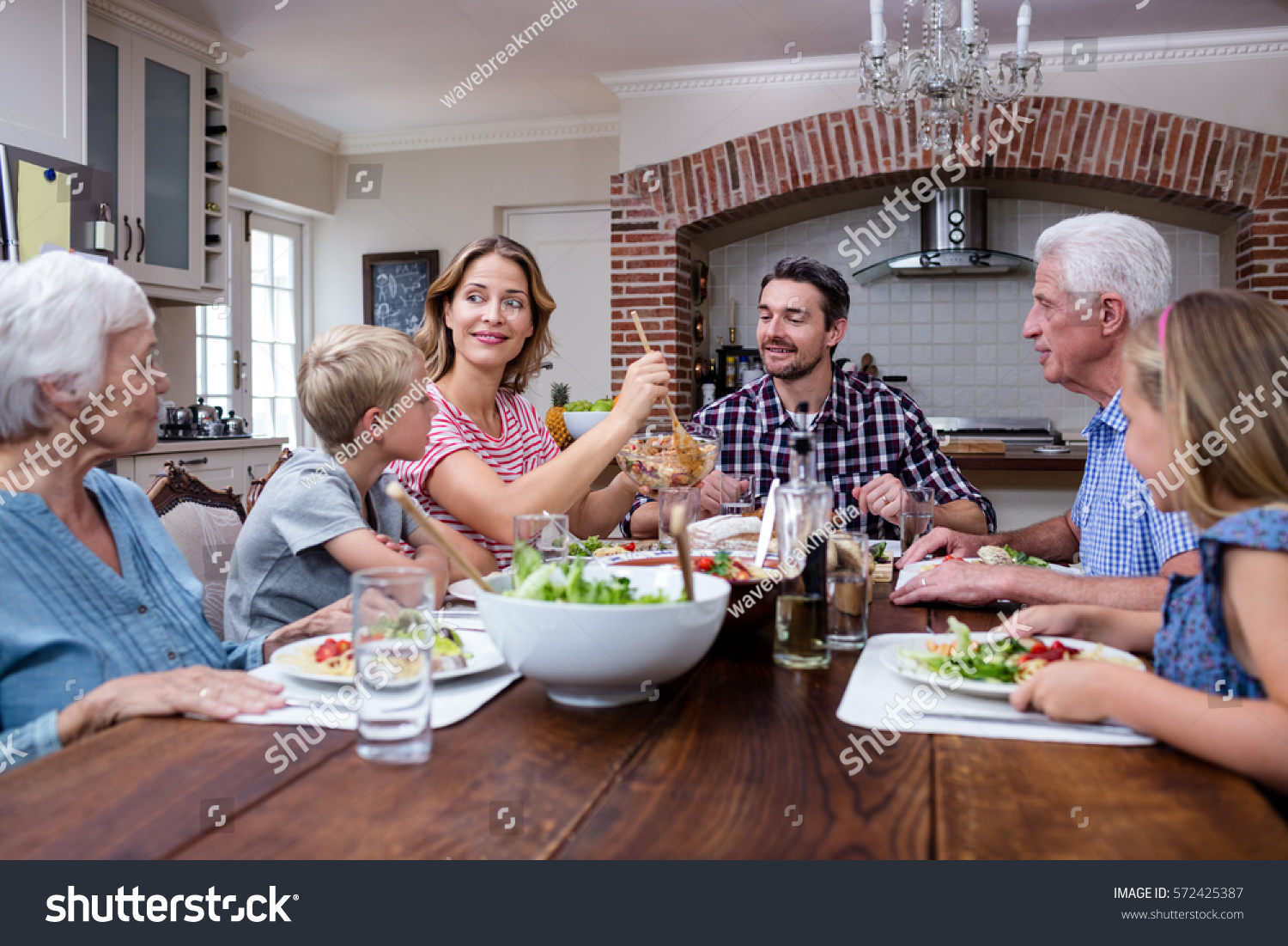 Woman Serving Food Her Family Kitchen Stock Photo 572425387 | Shutterstock