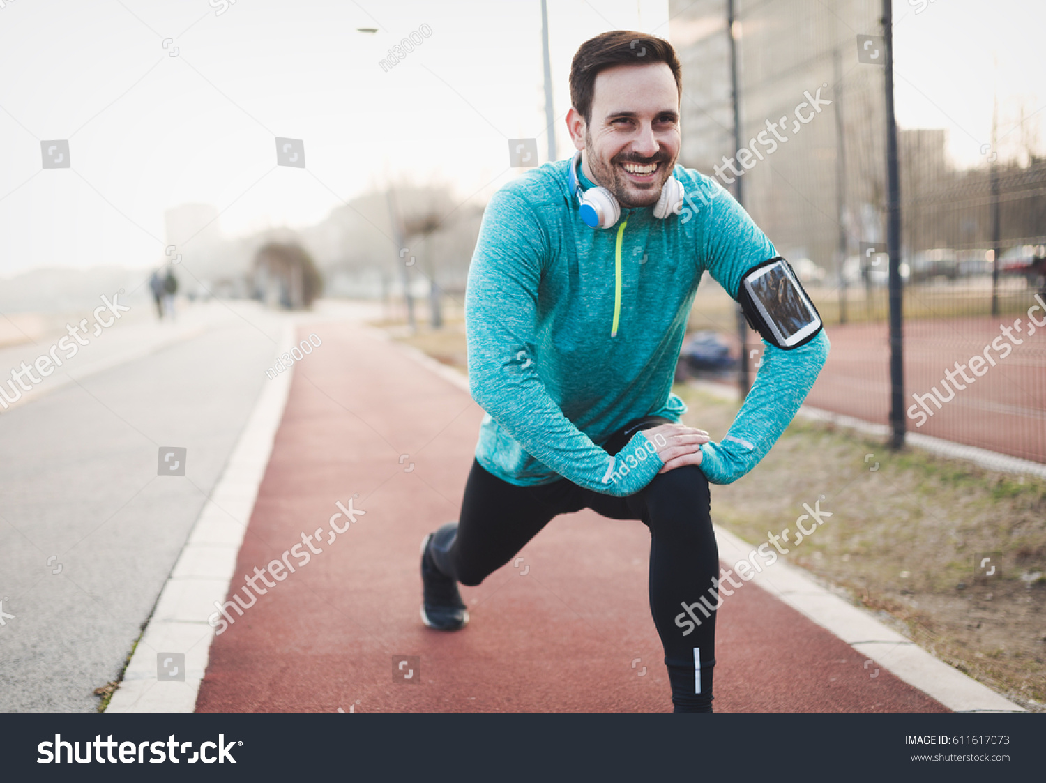 Handsome Man Stretching Before Exercising Running Stock Photo 611617073