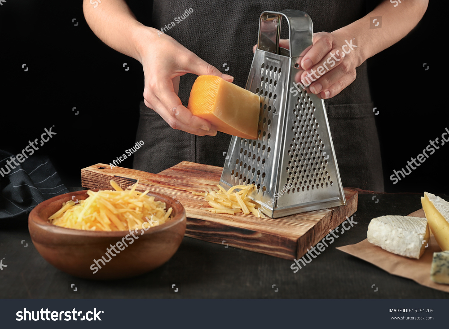 Woman Grating Cheese On Kitchen Table: стоковые изображения в HD и миллионы...