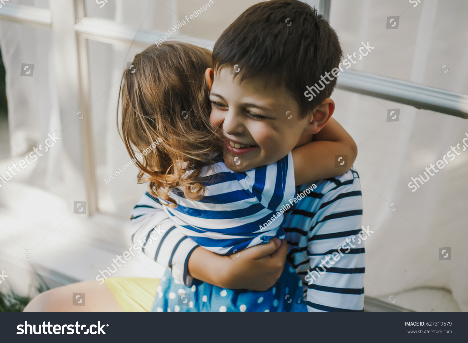 brother and sister hugging