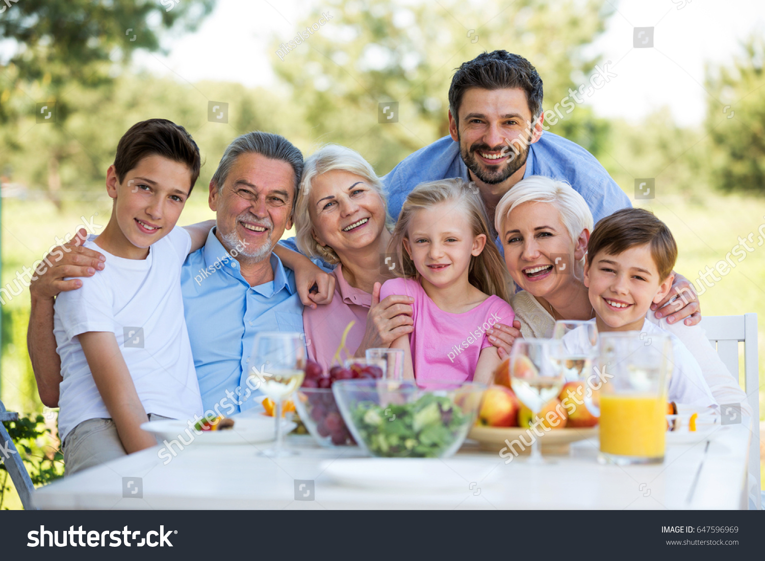 Family Sitting Table Outdoors Smiling Stock Photo 647596969 | Shutterstock