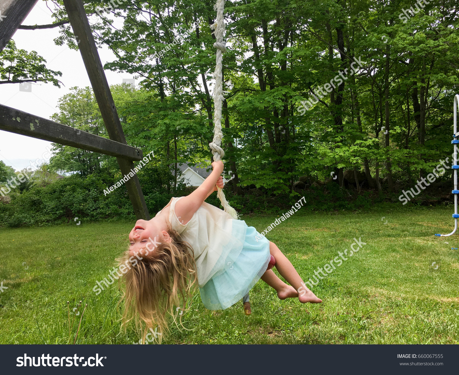 Young Girl Swinging Upside Down On Stock Photo 660067555 