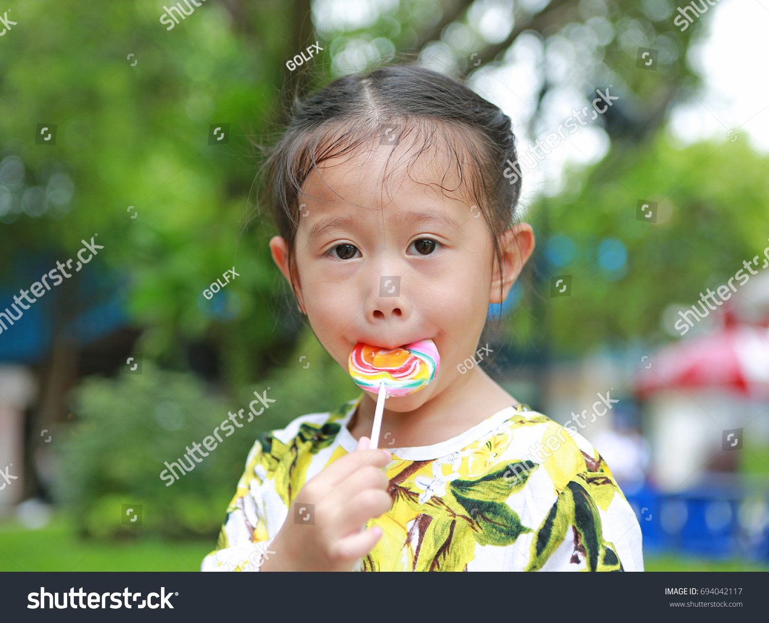 Little Asian Girl Eating Candy Lollipop Stock Photo 694042117 ...