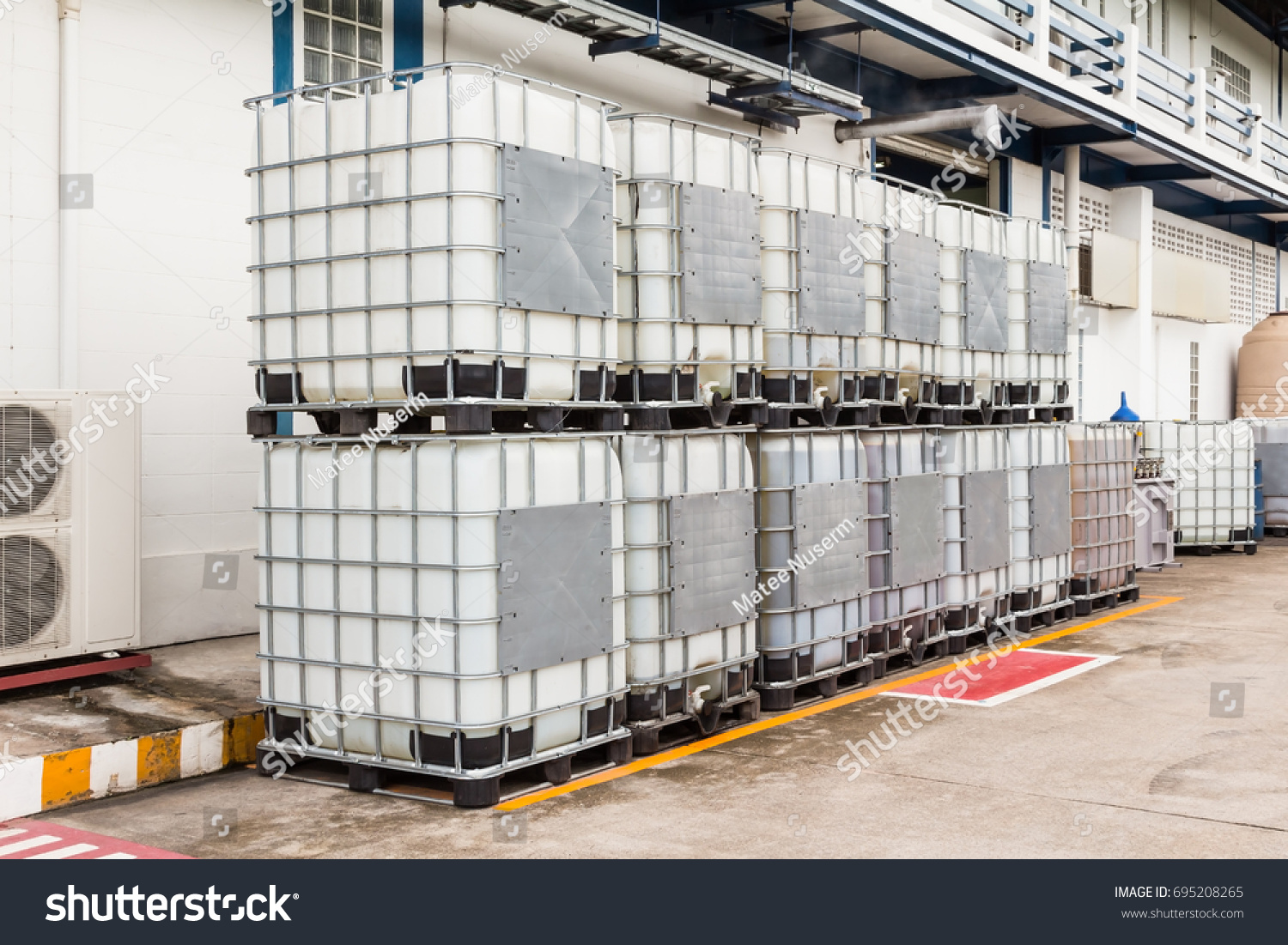 Bulk Plastic Oil Liquid Containers Metallic Stock Photo 695208265   Stock Photo Bulk Plastic Oil Or Liquid Containers With Metallic Cage 695208265 