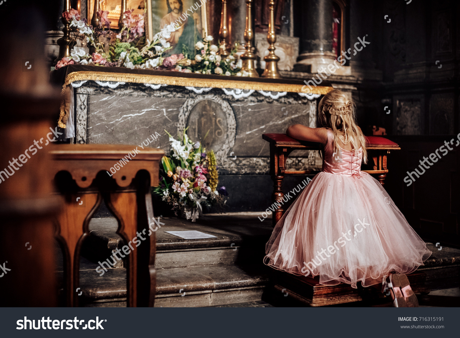 little girl praying in church