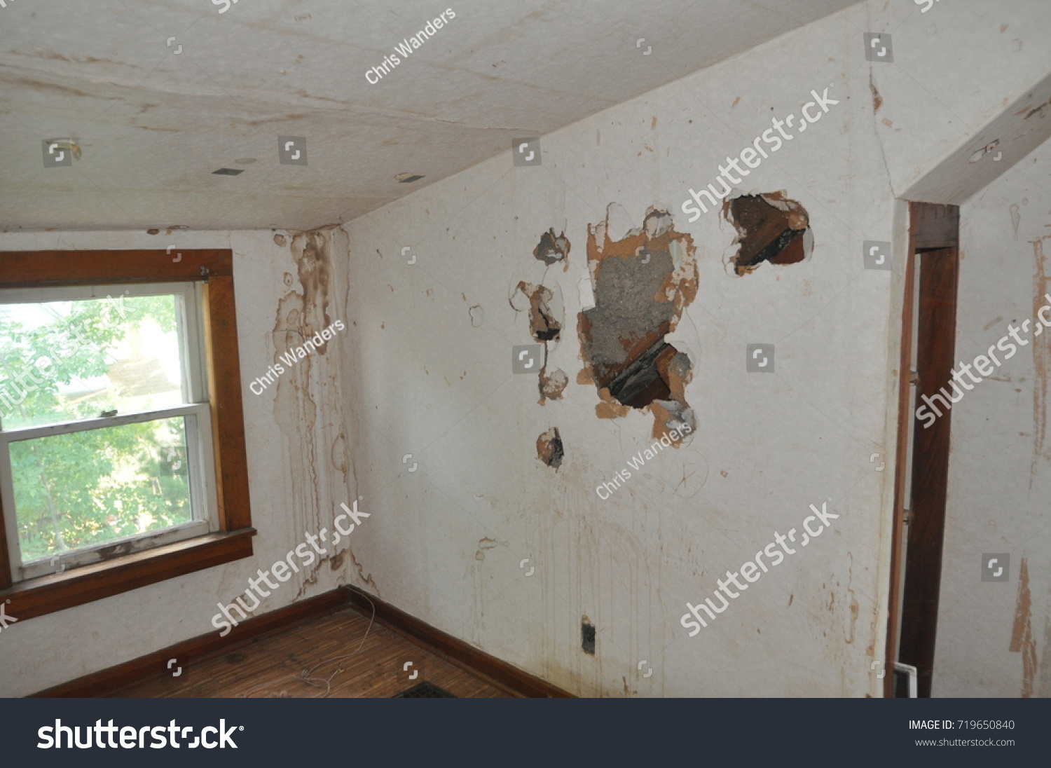 stock-photo-drywall-damage-with-holes-punched-in-wall-719650840.jpg