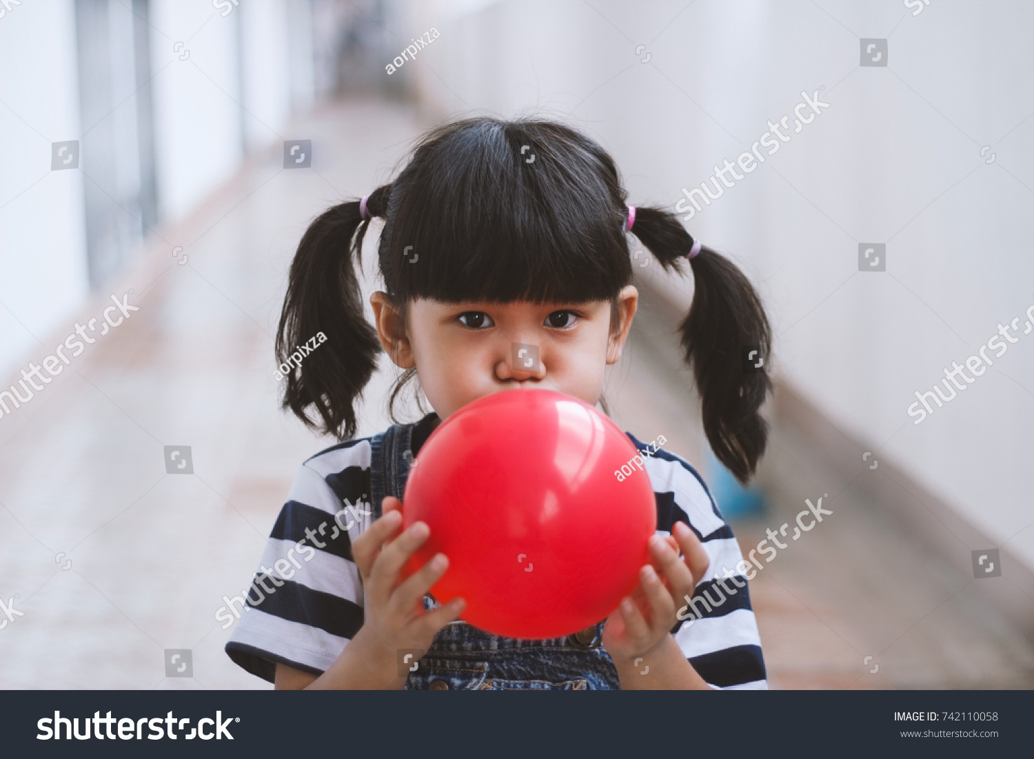 Girl Blowing Balloons