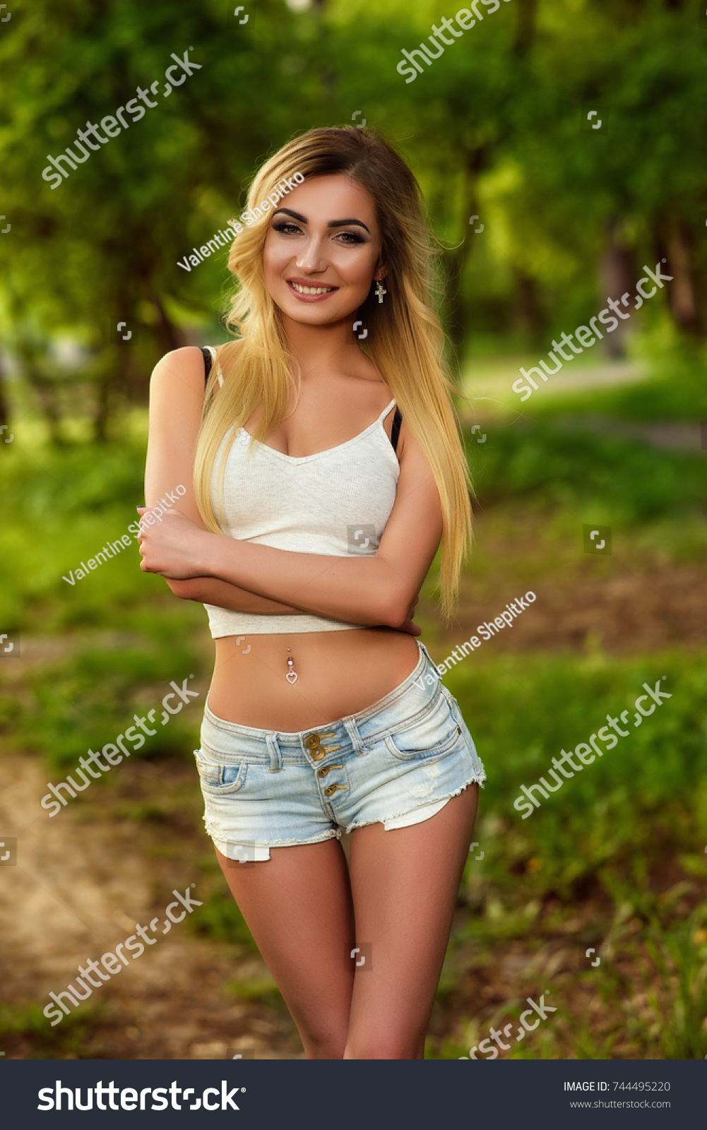 Sexy Blonde Woman White Top Jeans Stock picture