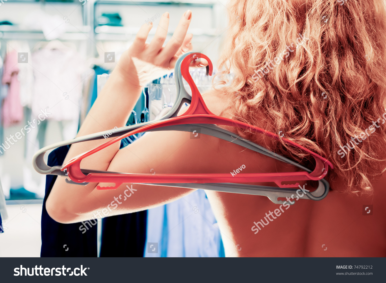 Naked Woman Two Empty Clothes Hangers Shutterstock