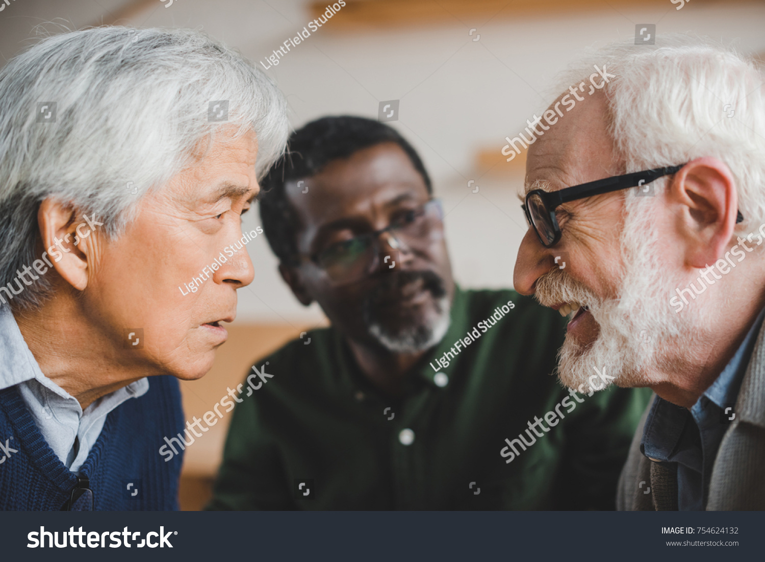 Group Serious Multiethnic Senior Friends Playing Stock Photo 754624132