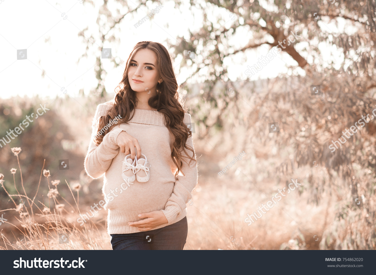 Smiling Pregnant Woman 2024 Year Old Stock Photo 754862020 Shutterstock   Stock Photo Smiling Pregnant Woman Year Old Holding Baby Boots Holding Tummy Posing In Field Looking At 754862020 