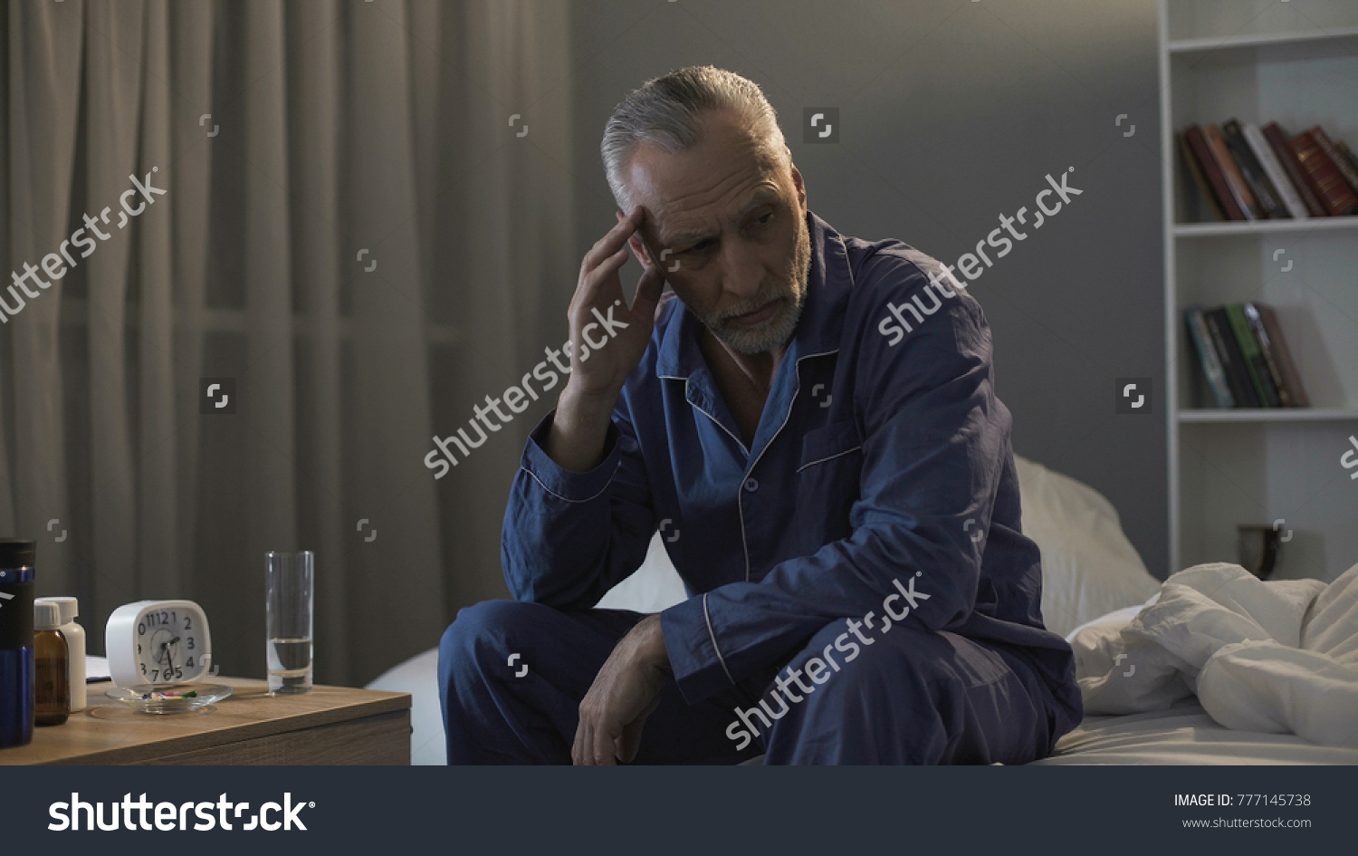 senior-male-sitting-bed-suffering-terrible-stock-photo-777145738