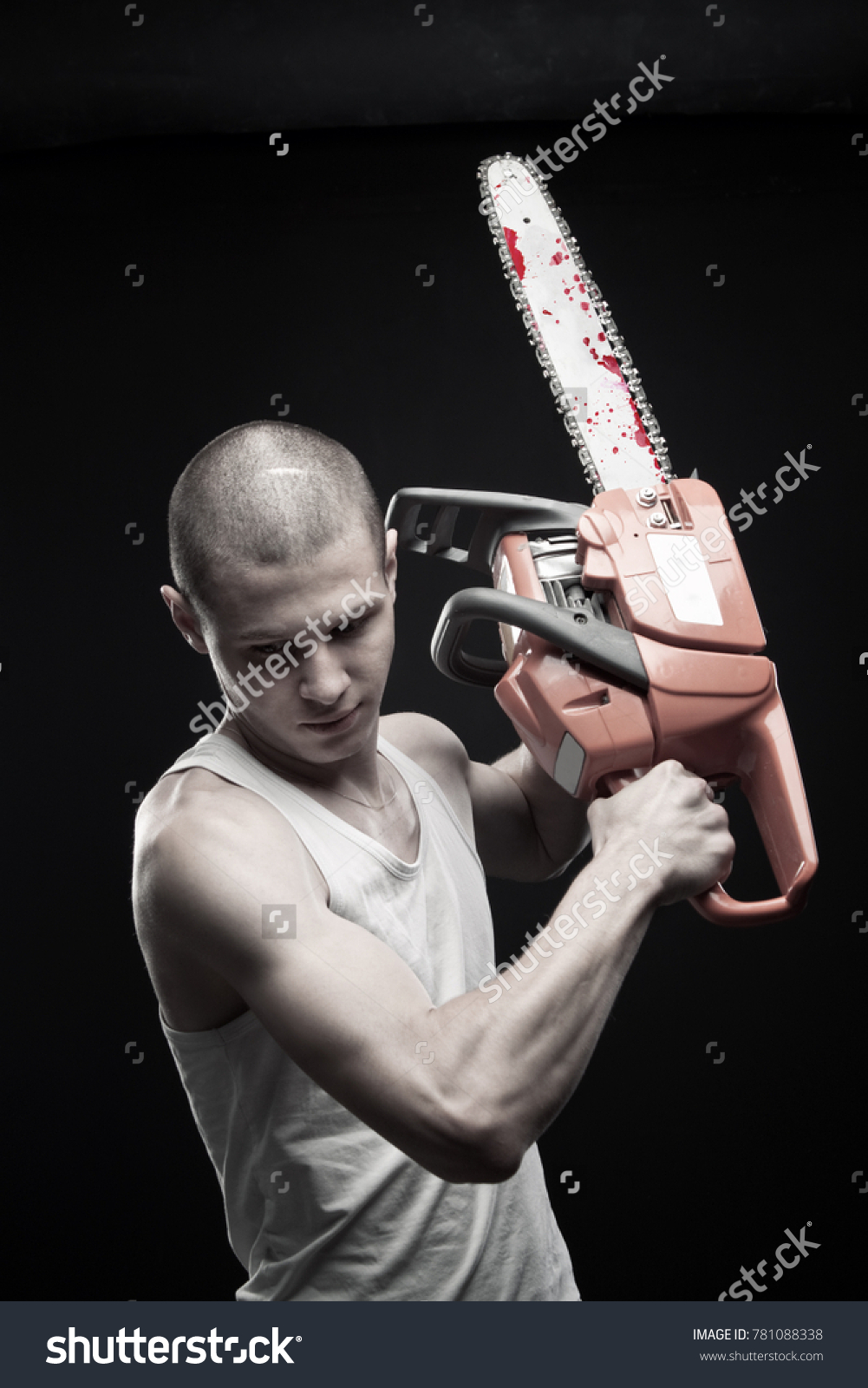 Стоковая фотография 781088338: Young Strong Guy Bloody Chainsaw Posing Shut...