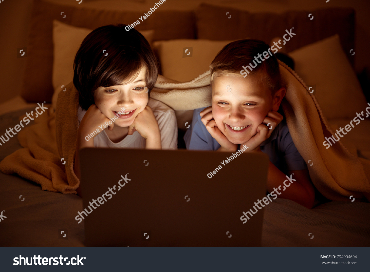 寝る前にベッドで本を読む母子写真素材 Shutterstock