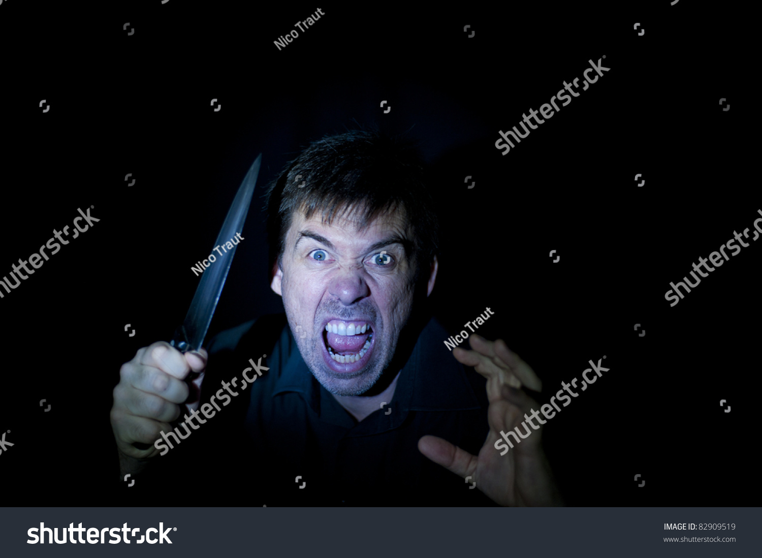 crazy-person-angry-expression-wielding-knife-stock-photo-82909519