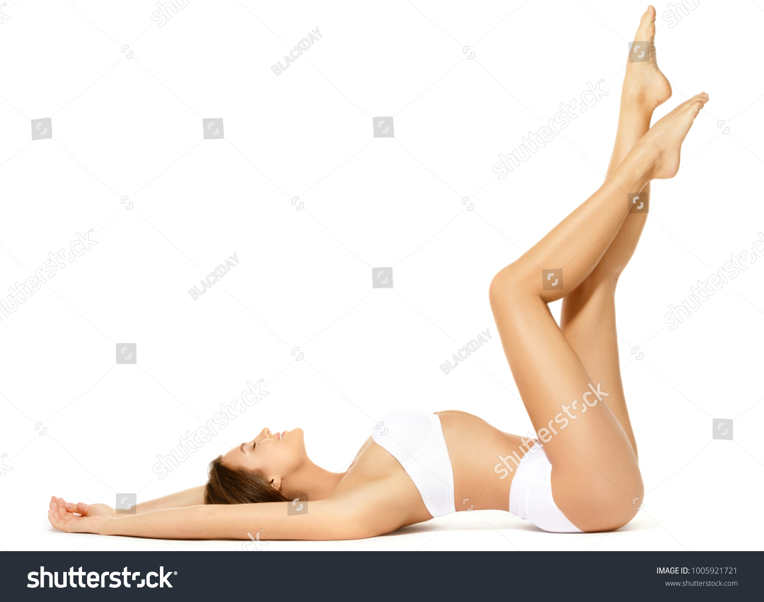 Woman with a beautiful long legs isolated on white background #1005921721