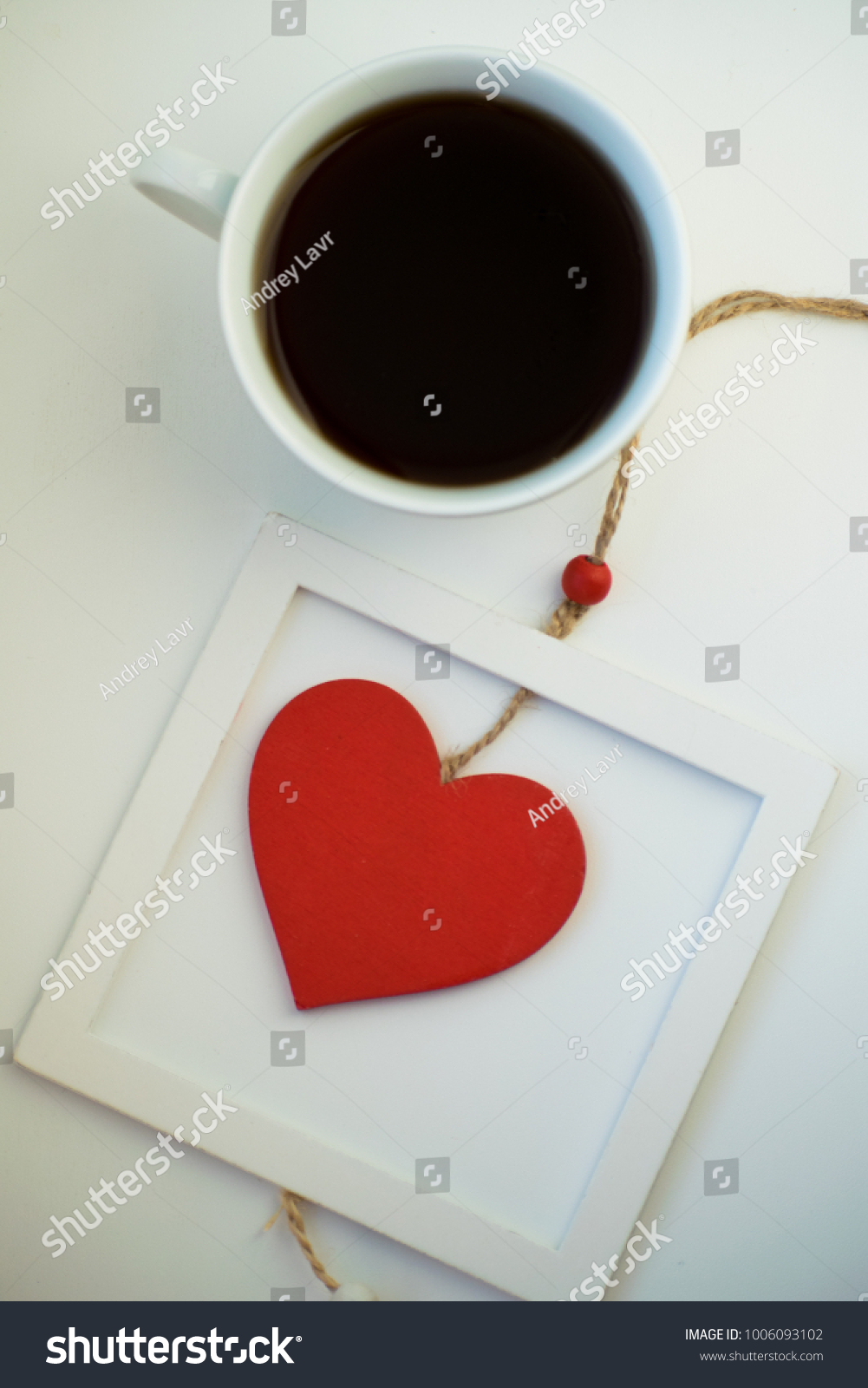 Cup of love, coffee with red heart. Red heart on a rope in the wooden frame. Valentine's day. Morning. The 14th of February. #1006093102