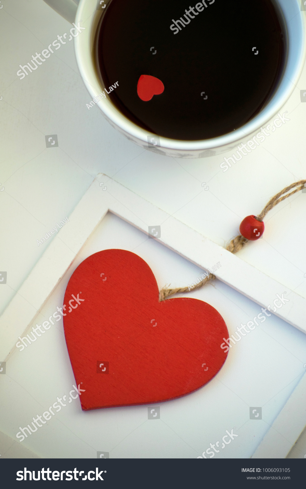 Cup of love, coffee with red heart. Red heart on a rope in the wooden frame. Valentine's day. Morning. The 14th of February. #1006093105