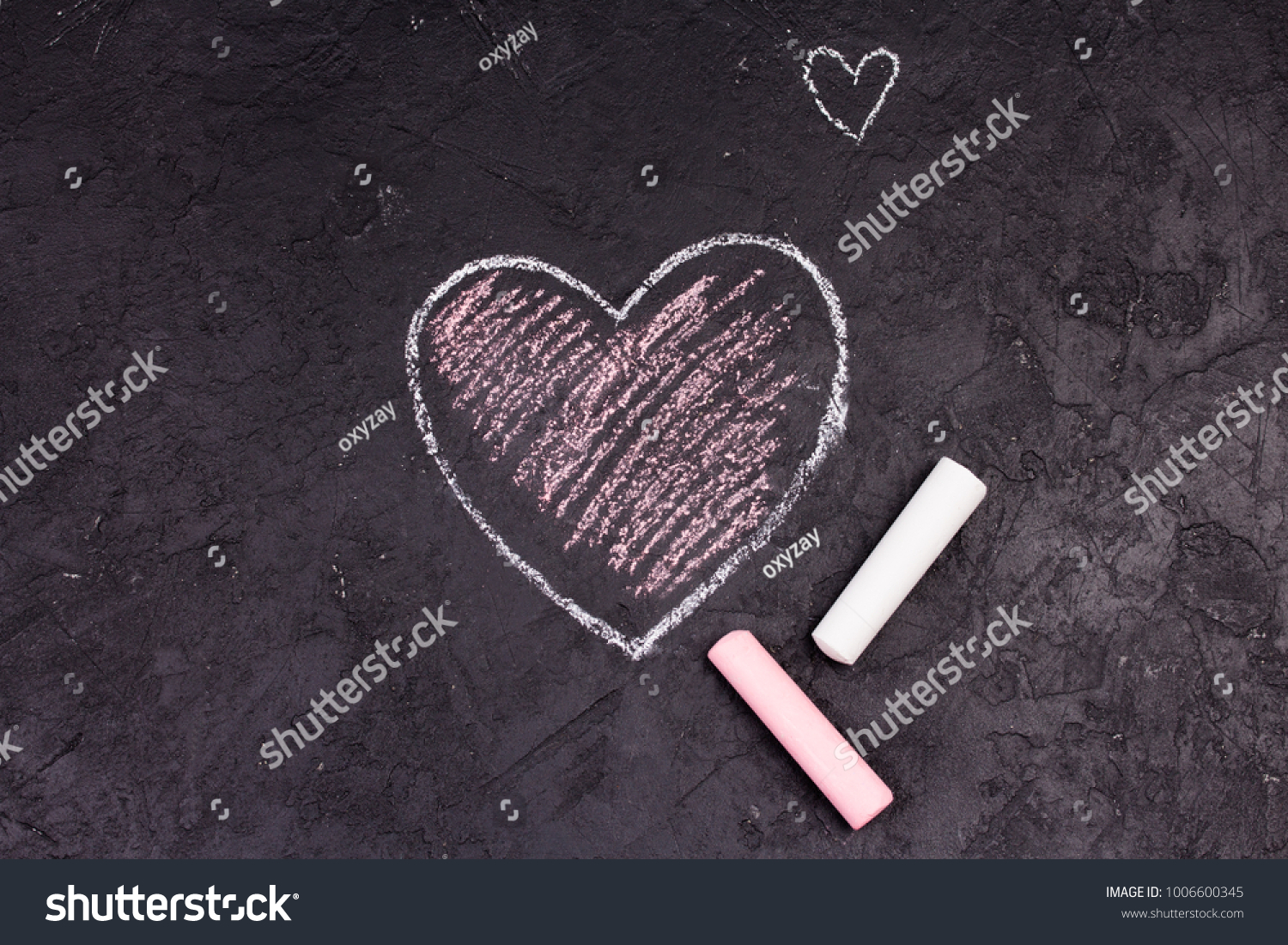 Chalk drawing of pink heart on the blackboard. #1006600345